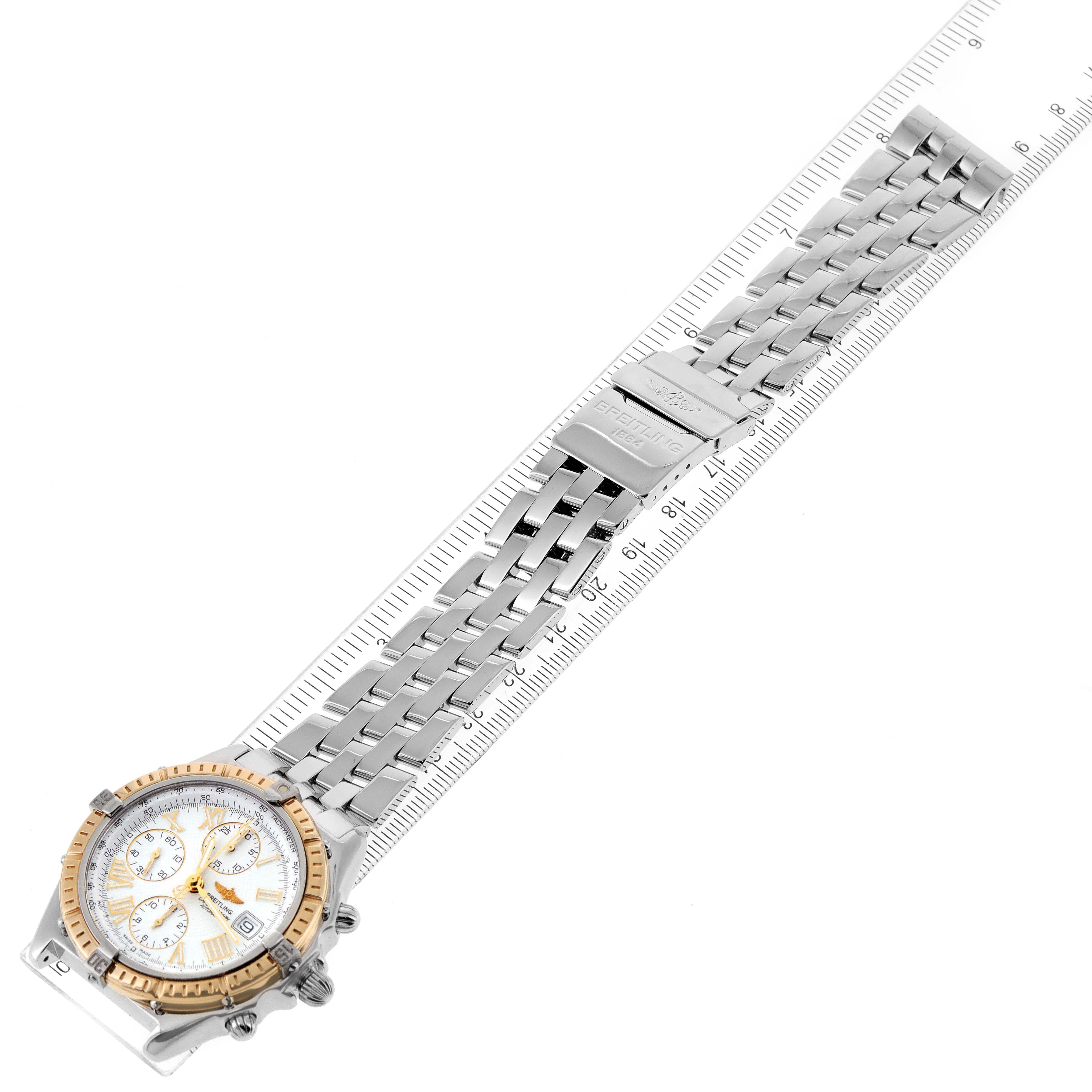 The image shows a top-down view of the Breitling Chronomat D13055 Men's Steel and Gold (two tone) White Dial D13055 Men's Steel and Gold (two tone) White Dial watch, displaying its face, bezel, and metal bracelet alongside a ruler.
