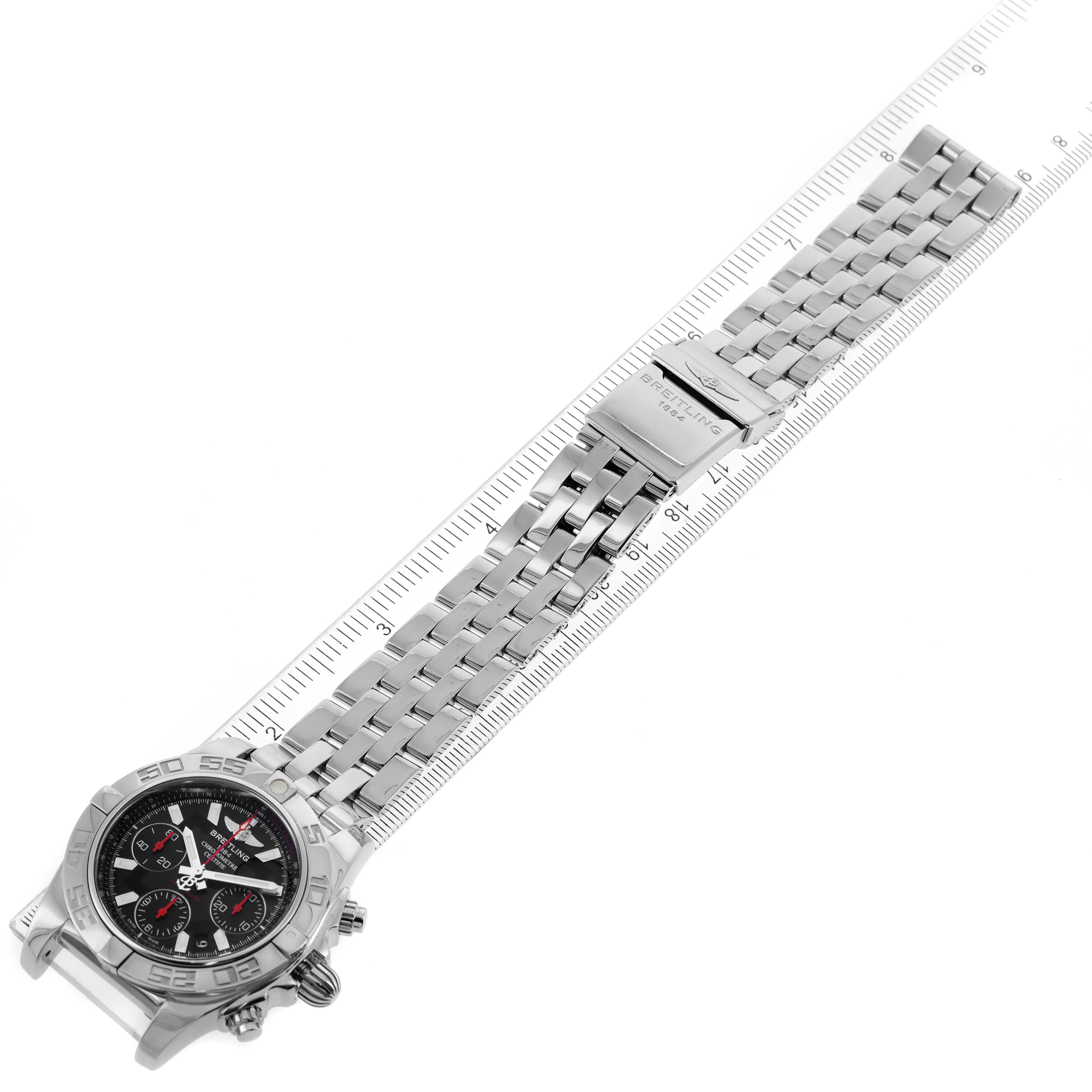 The image shows a Breitling Chronomat AB0141 Men's Stainless Steel Black Dial AB0141 Men's Stainless Steel Black Dial watch at an oblique angle with a metal bracelet extended and a ruler beside it.