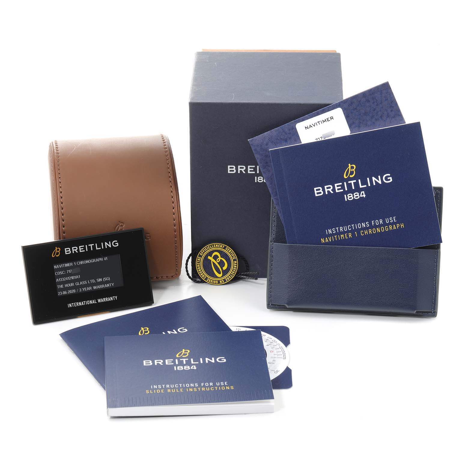 The image shows accessories for a Breitling Navitimer A13324 Men
s Stainless Steel Black Dial A13324 Men
s Stainless Steel Black Dial watch, including manuals, warranty card, box, and a leather travel case.