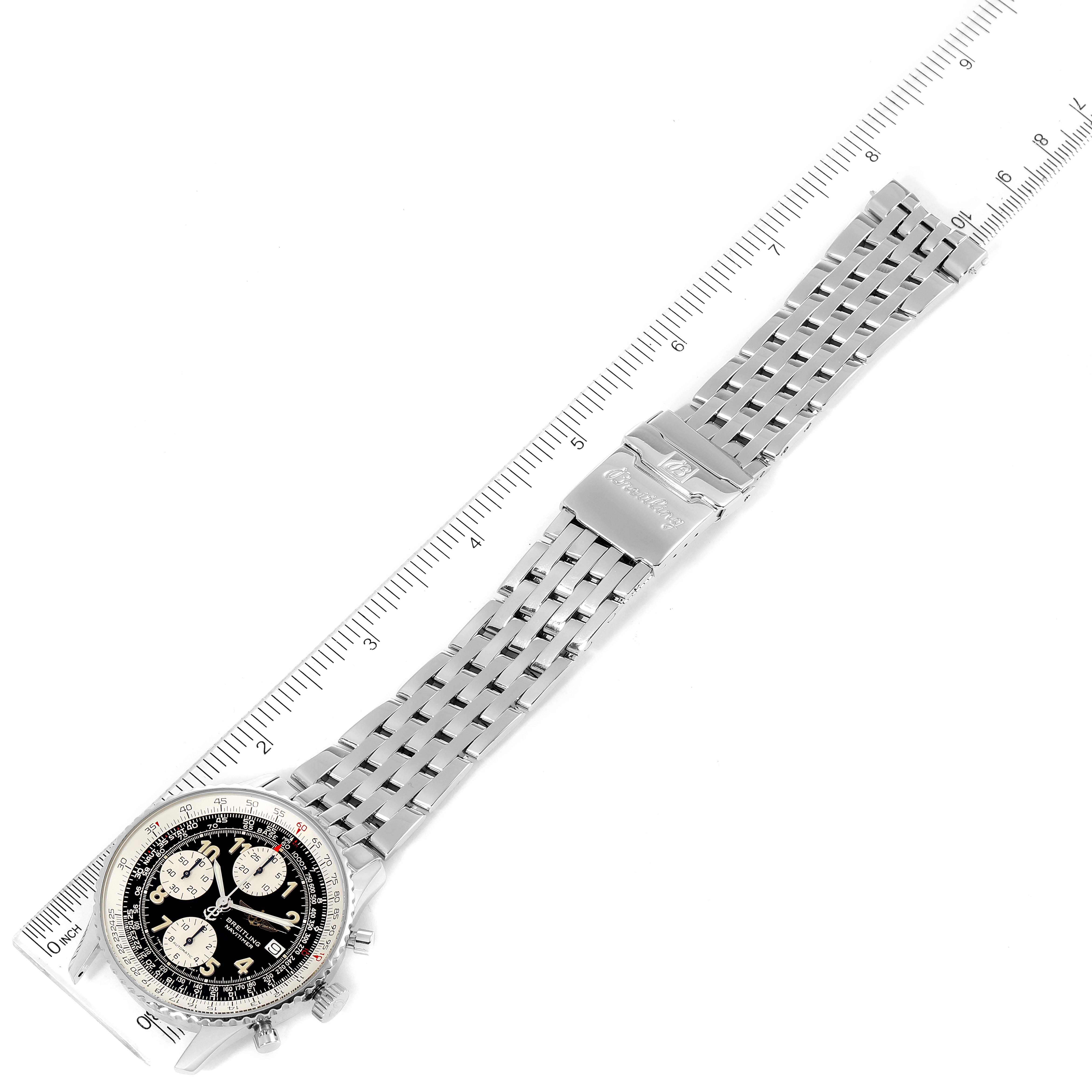 This image shows a top view of a Breitling Navitimer A13022 Men
s Stainless Steel Black Dial A13022 Men
s Stainless Steel Black Dial watch with a stainless steel bracelet on a ruler for scale.