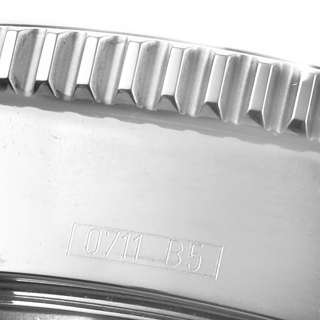 This close-up image shows the grooved edge of the bezel and part of the casing of a Breitling Superocean A17364 Men
s Stainless Steel Black Dial A17364 Men
s Stainless Steel Black Dial watch.