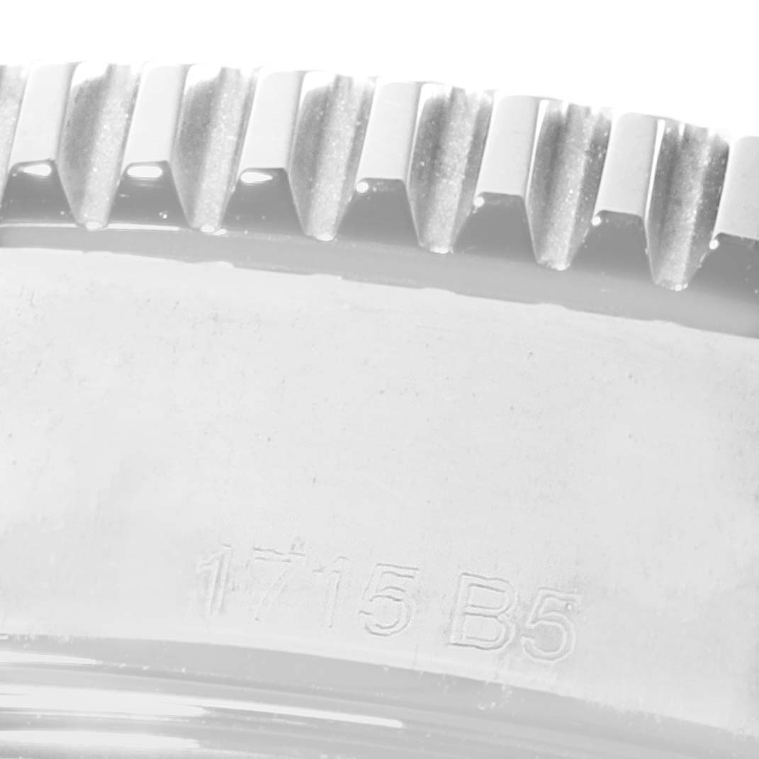 This close-up image shows the bezel edge and part of the case of a Breitling Superocean A17365 Men
s Stainless Steel Black Dial A17365 Men
s Stainless Steel Black Dial watch.