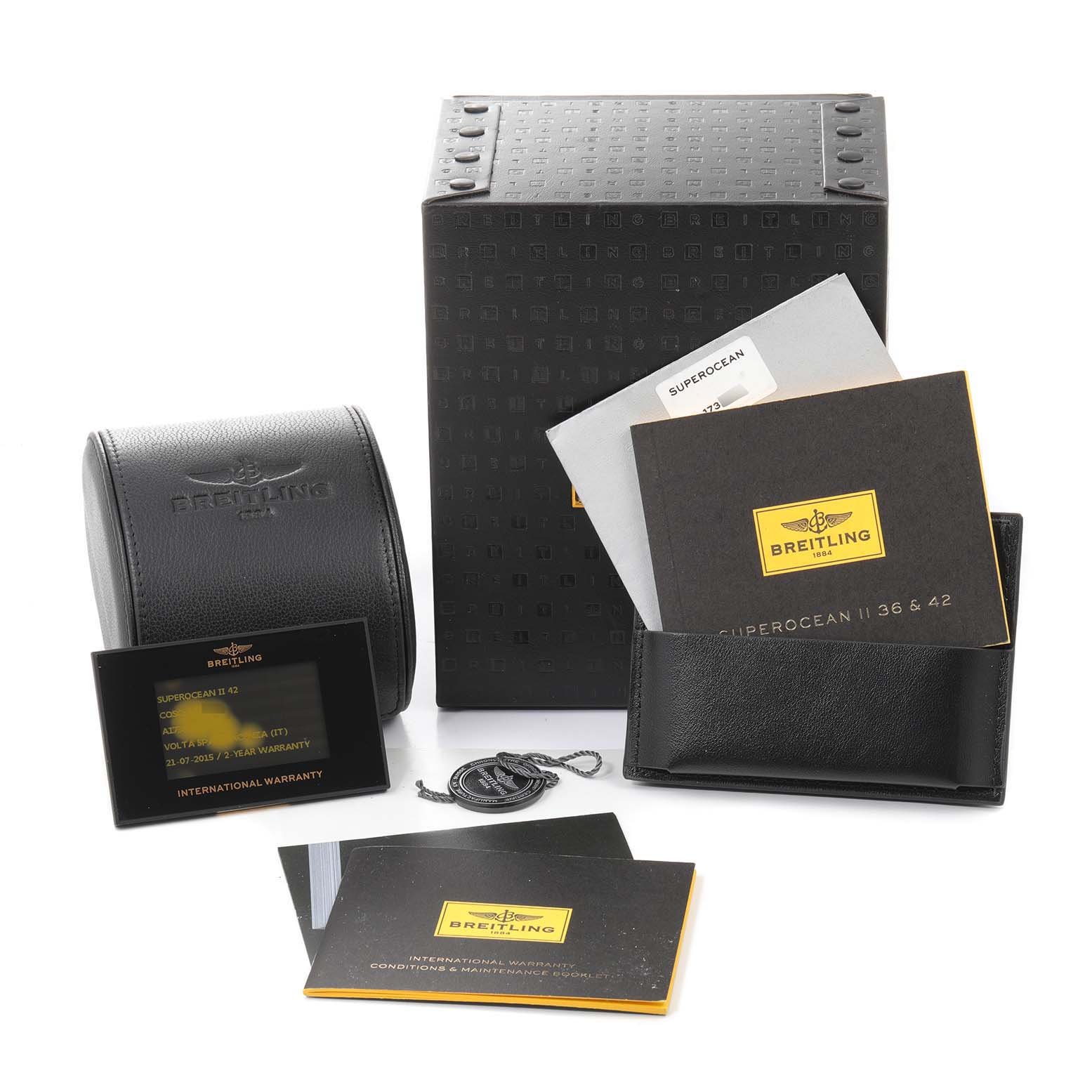 The image shows the Breitling Superocean A17365 Men
s Stainless Steel Black Dial A17365 Men
s Stainless Steel Black Dial watch
s box, manuals, warranty card, and an accessory pouch.