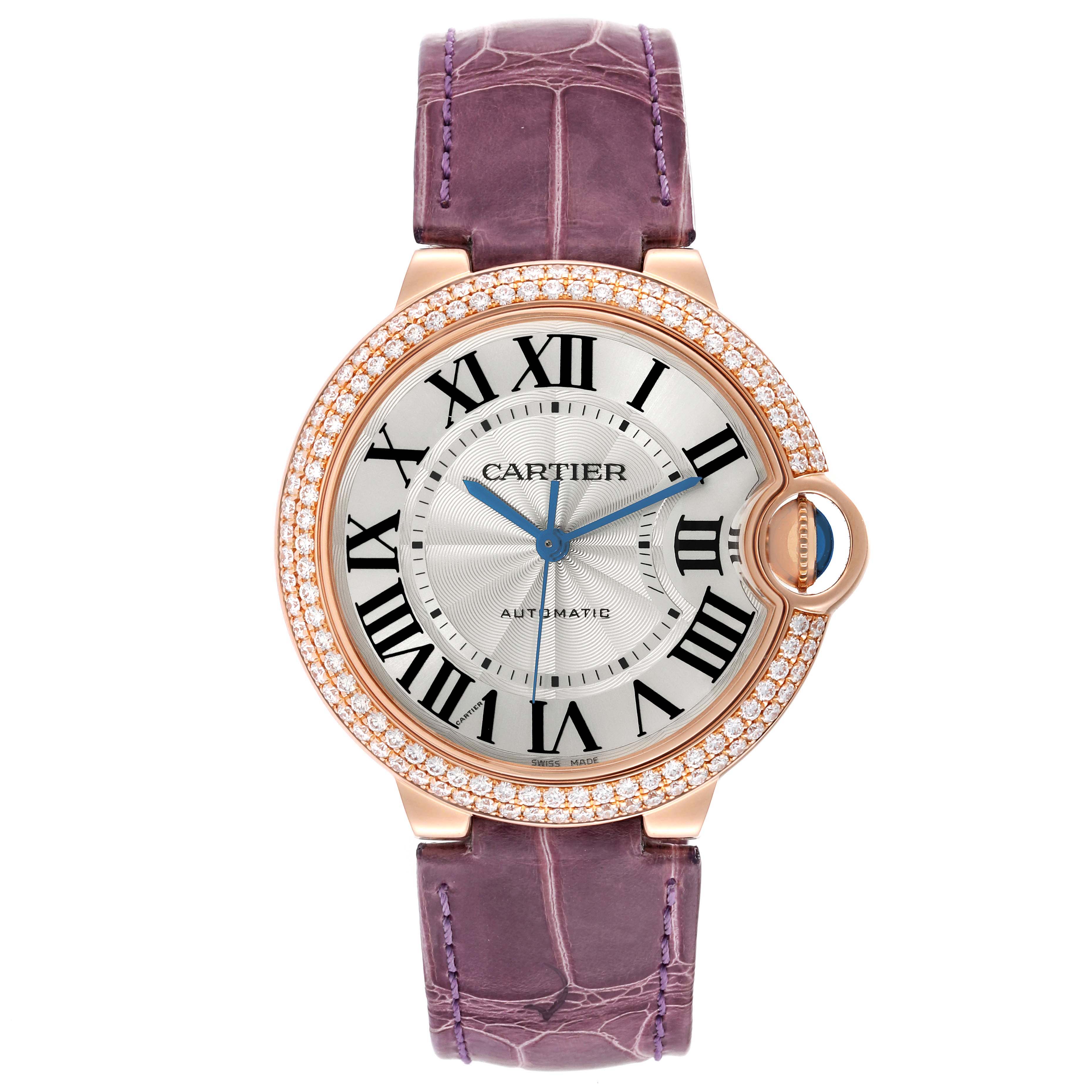The Cartier Ballon Bleu WE900551 Women's Rose Gold Silver Dial watch is shown from a top-down angle, highlighting the face, bezel, and purple strap.