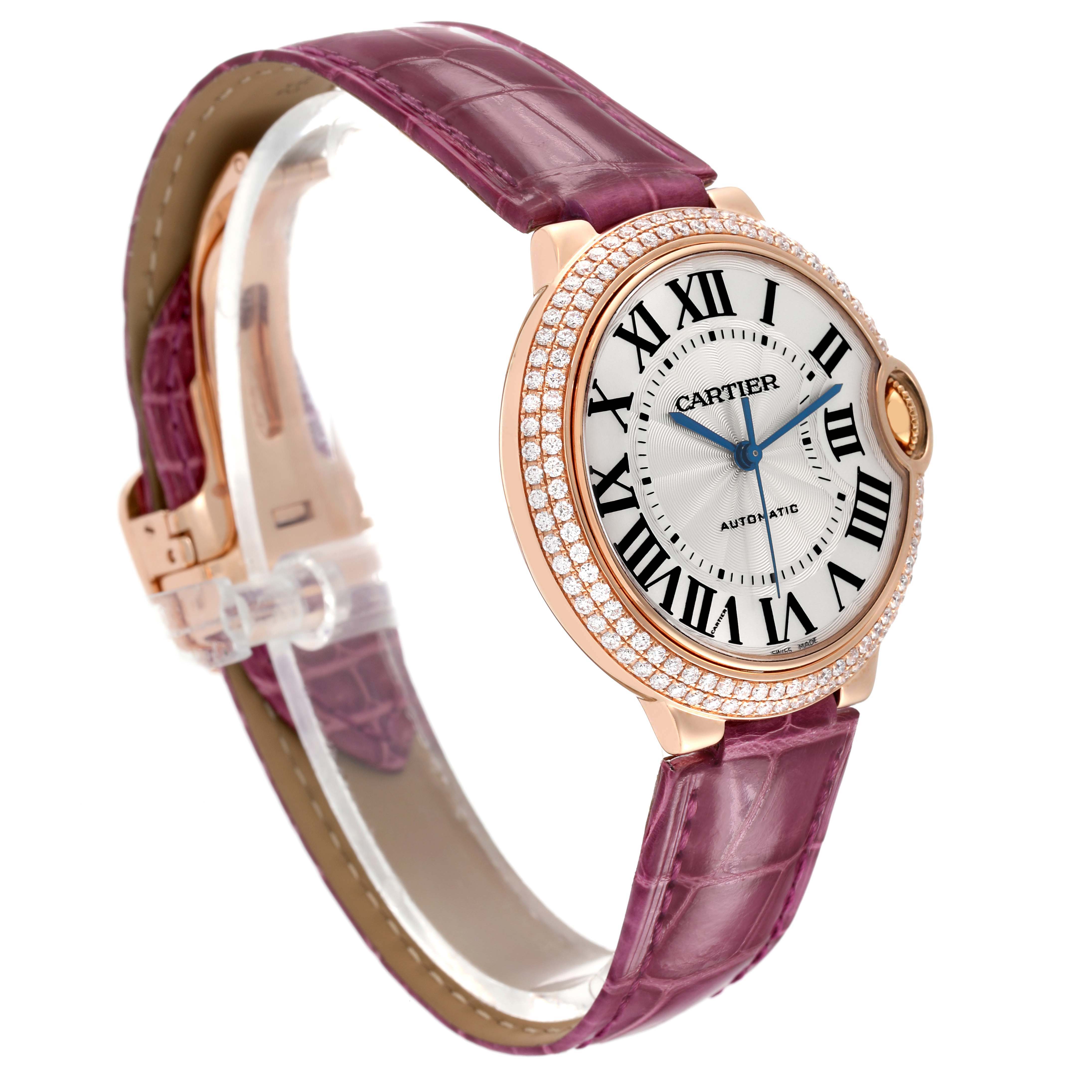 The Cartier Ballon Bleu WE900551 Men's Rose Gold Silver Dial watch is shown from a three-quarter angle, highlighting the face, pink strap, and diamond-set bezel.