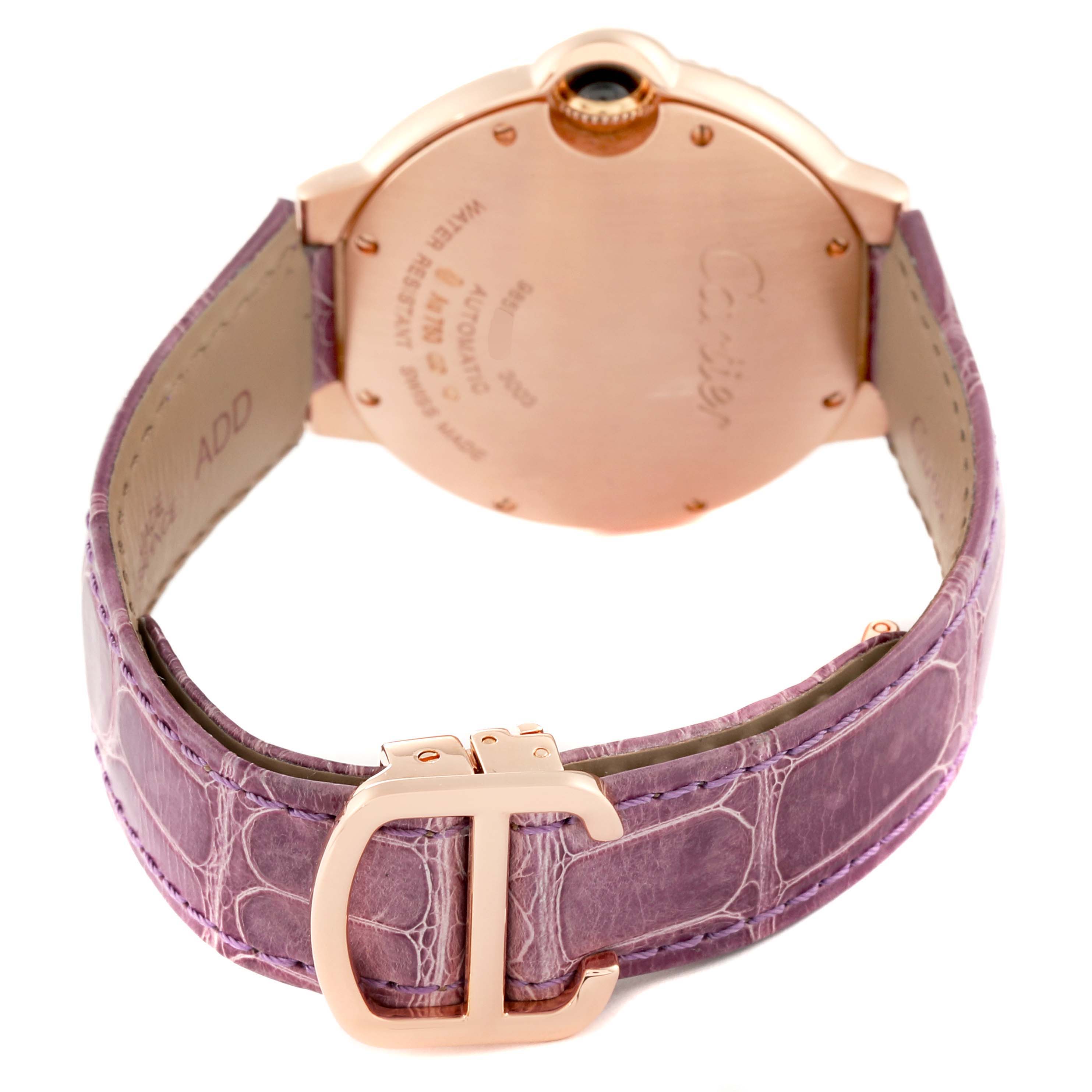 The image shows the back of a Cartier Ballon Bleu WE900551 Women's Rose Gold Silver Dial WE900551 Women's Rose Gold Silver Dial watch, highlighting the case back, crown, and purple leather strap with a Cartier buckle.