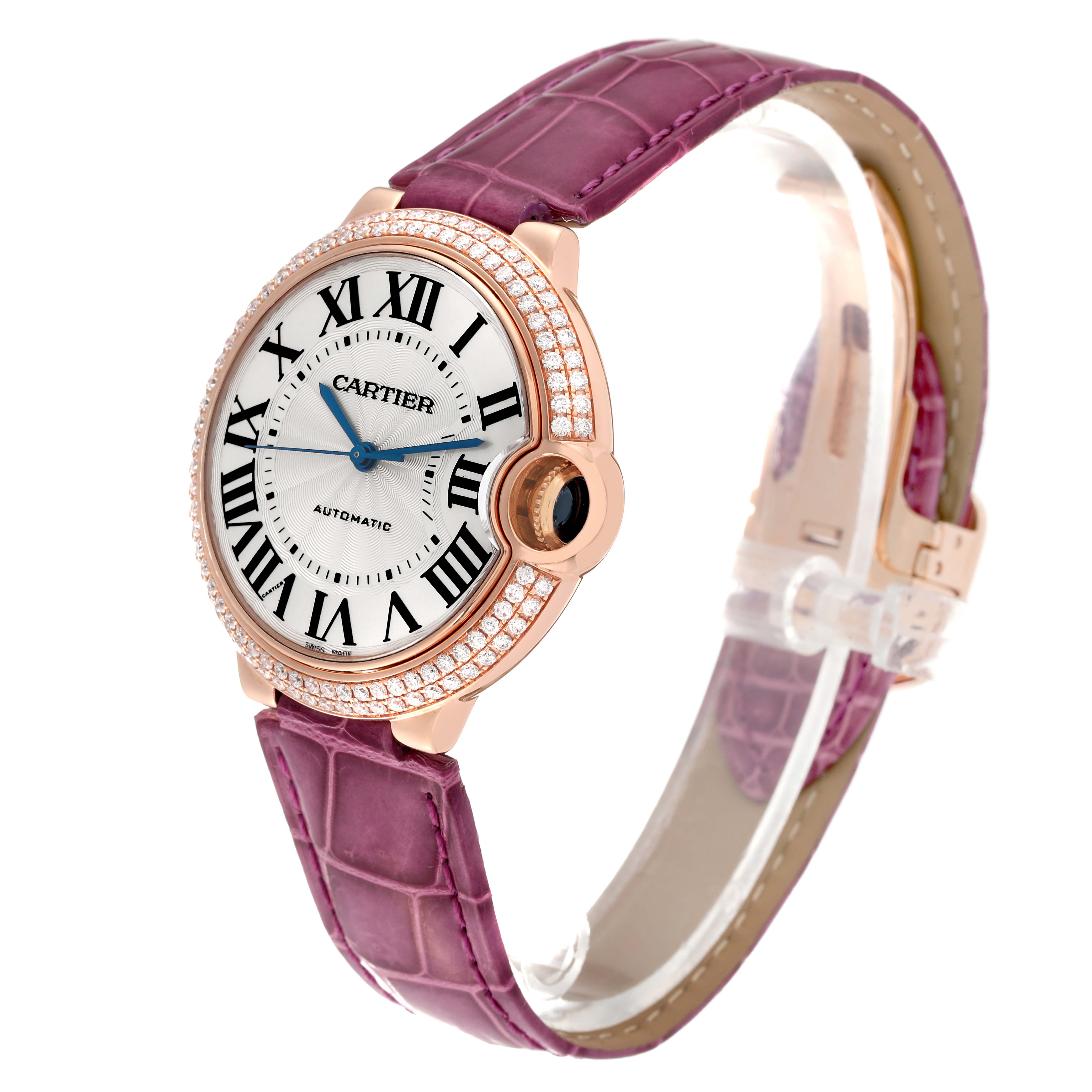 The Cartier Ballon Bleu WE900551 Women's Rose Gold Silver Dial WE900551 Women's Rose Gold Silver Dial watch is shown at an angle highlighting its face, bezel, crown, and purple leather strap.