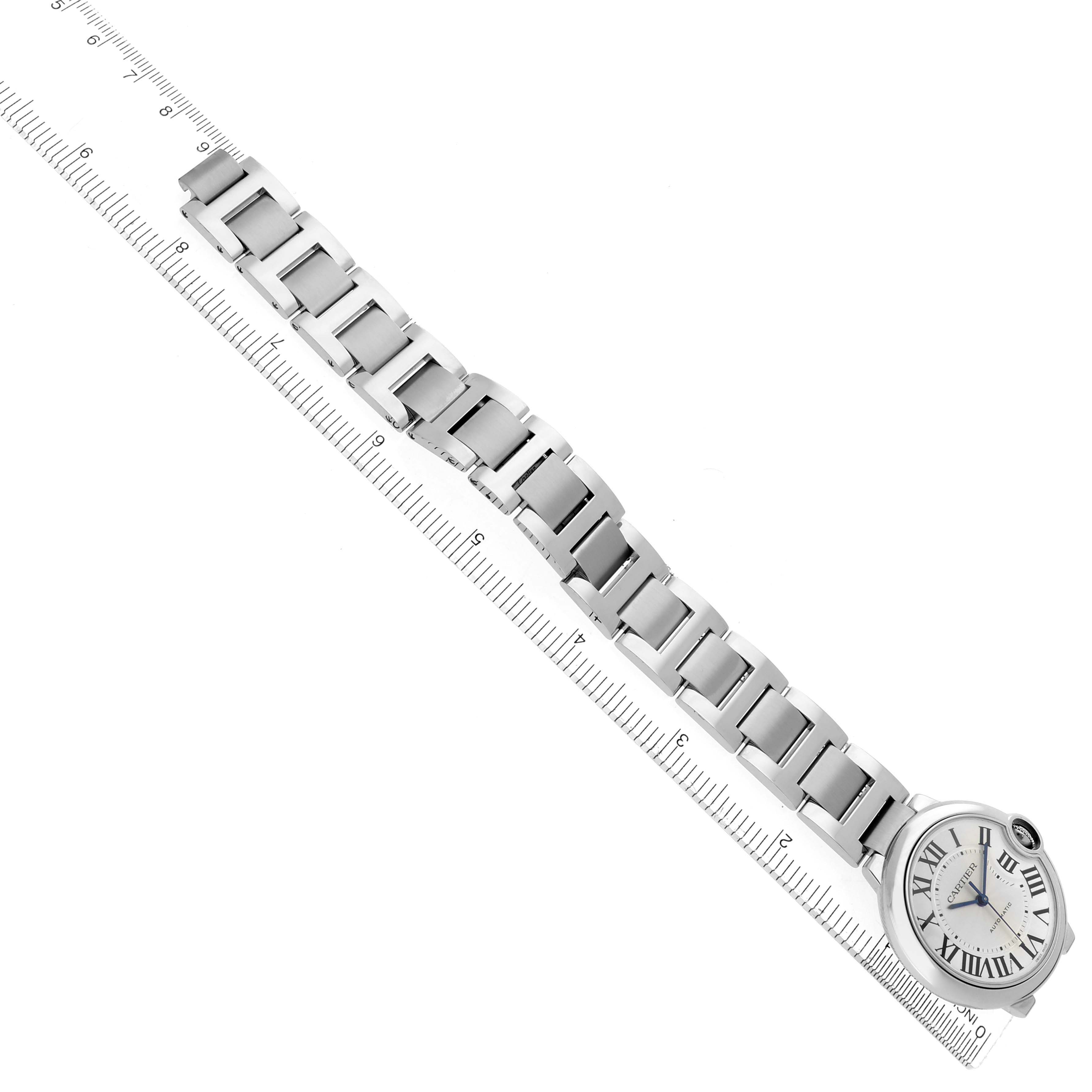 The Cartier Ballon Bleu W69017Z4 Men
s Stainless Steel Silver Dial W69017Z4 Men
s Stainless Steel Silver Dial watch is shown flat with its strap extended alongside a ruler.