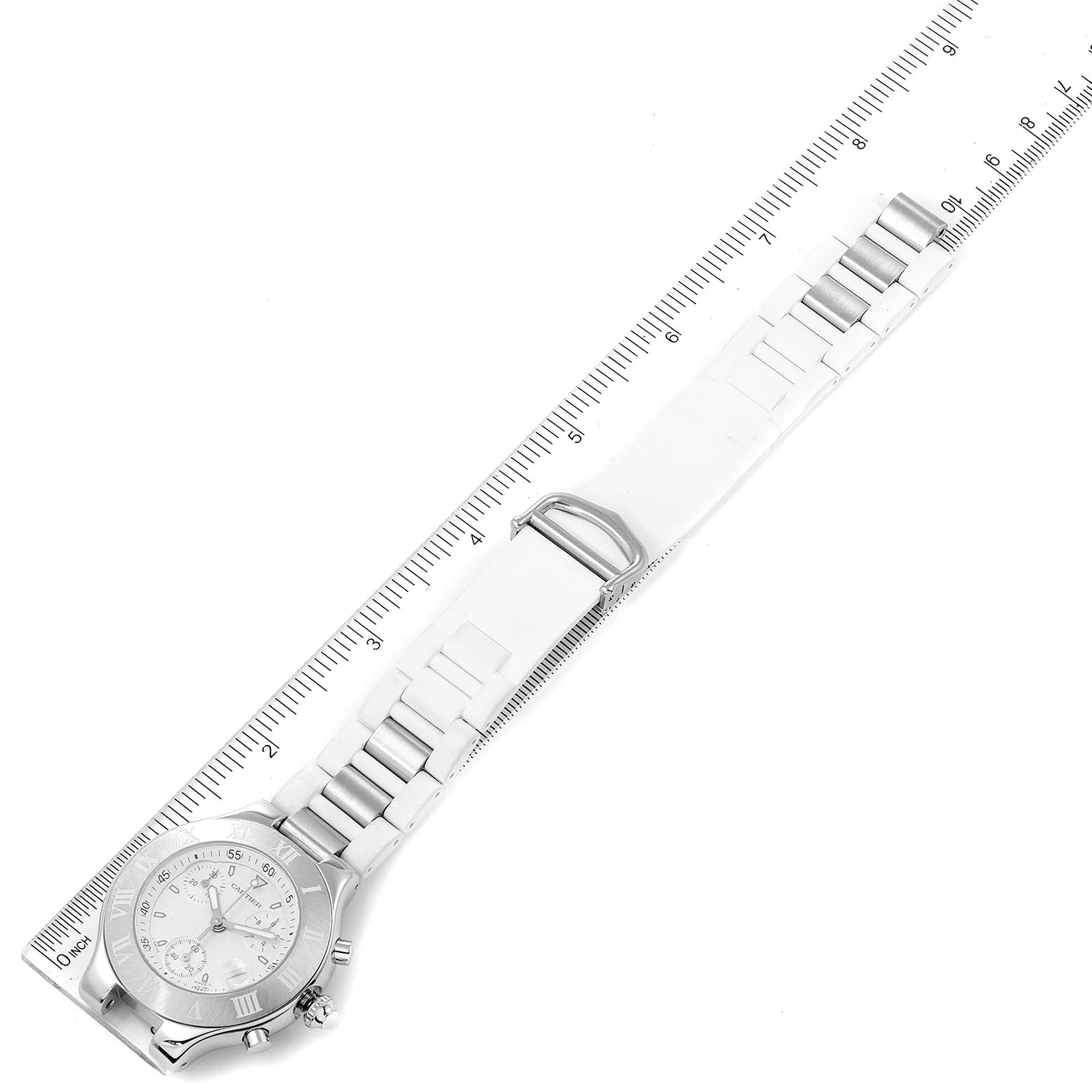 The image shows a Cartier Must 21 Chronoscaph W10184U2 Men's Stainless Steel White Dial W10184U2 Men's Stainless Steel White Dial watch lying flat with its bracelet extended beside a ruler.