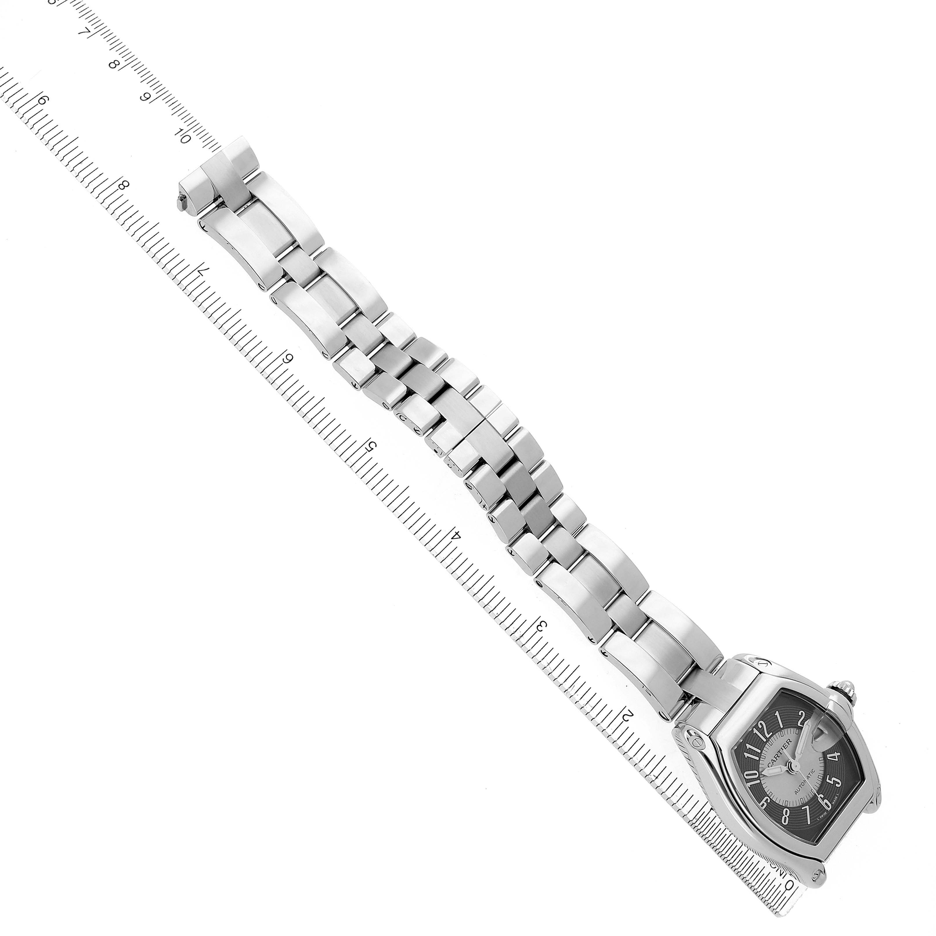 The Cartier Roadster W62001V3 Men
s Stainless Steel Grey Dial W62001V3 Men
s Stainless Steel Grey Dial watch is shown diagonally, displaying the full bracelet and case beside a ruler for scale.