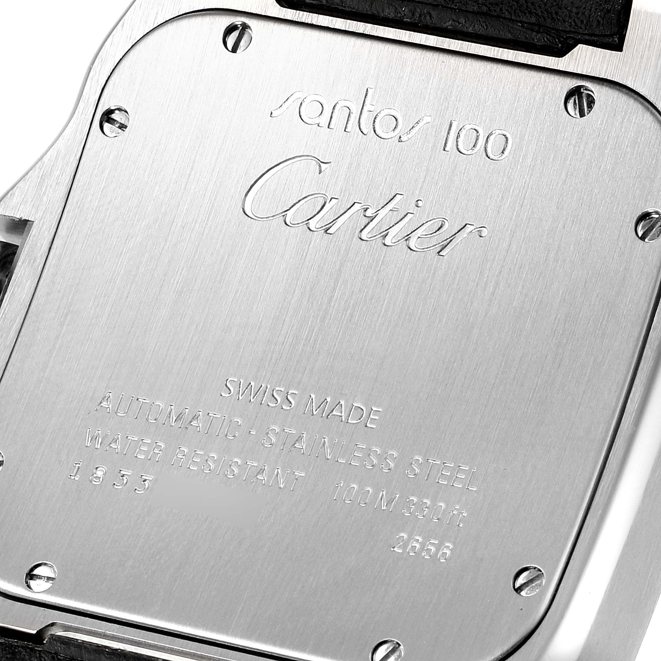This image shows the back case of a Santos 100 watch by Cartier, highlighting the engravings and screws.