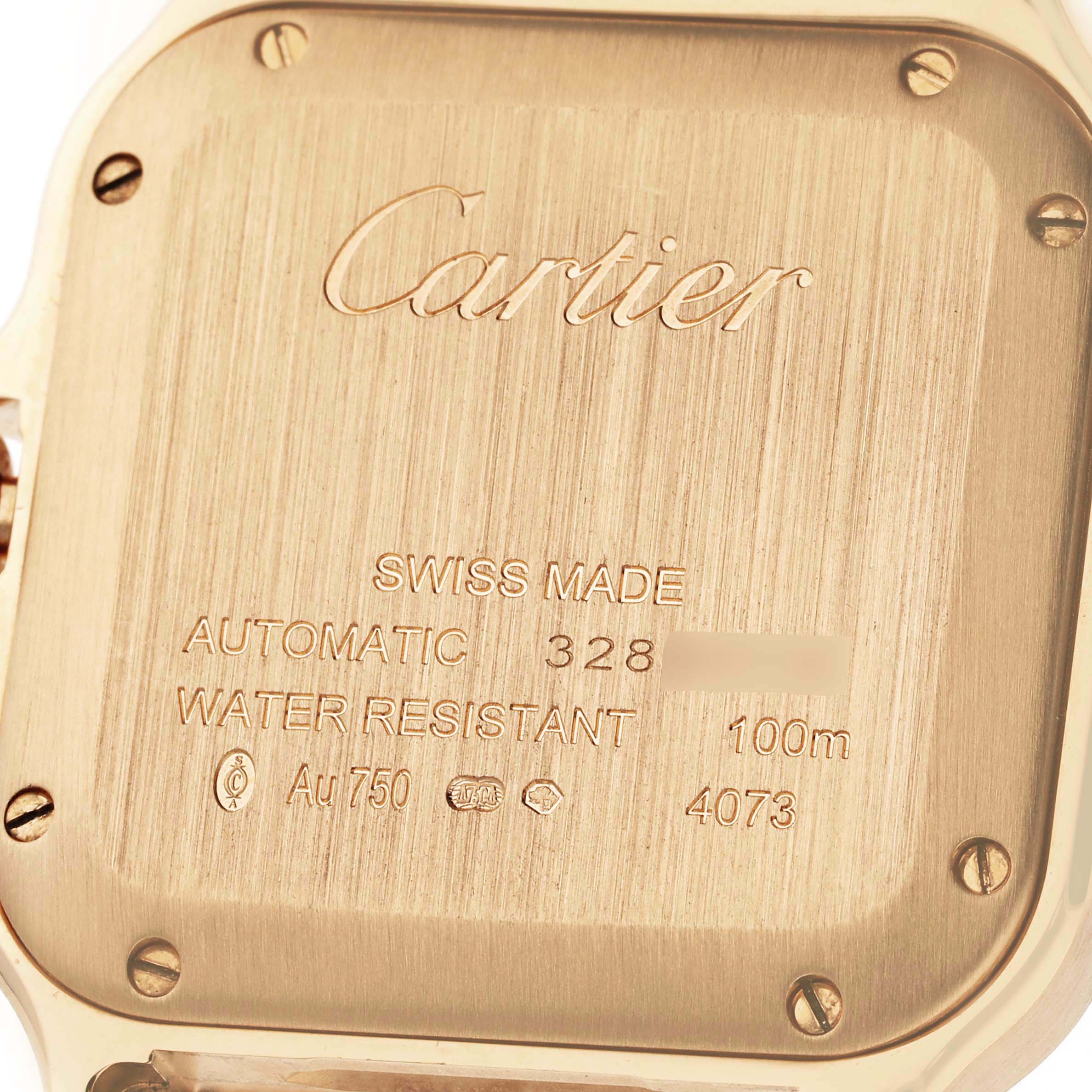 This image shows the back case of a Cartier Santos WJSA0008 Men's Yellow Gold Silver Dial WJSA0008 Men's Yellow Gold Silver Dial watch displaying engraved details.