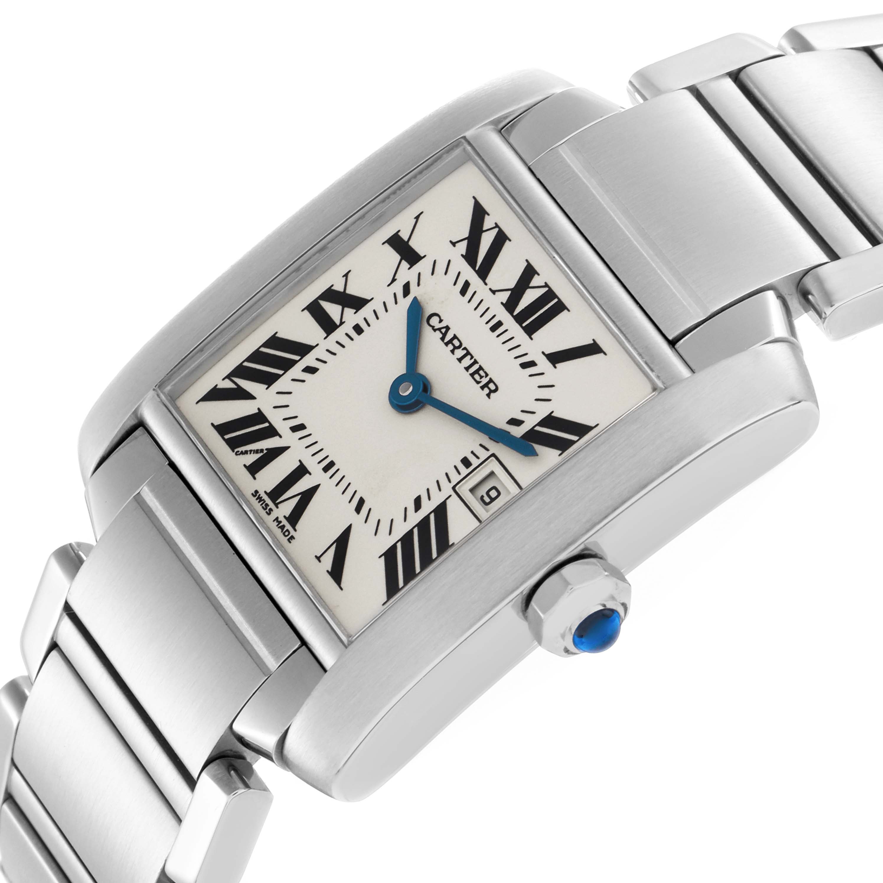 The Cartier Tank Française watch is shown at an angle highlighting the face, Roman numerals, and part of the steel bracelet.