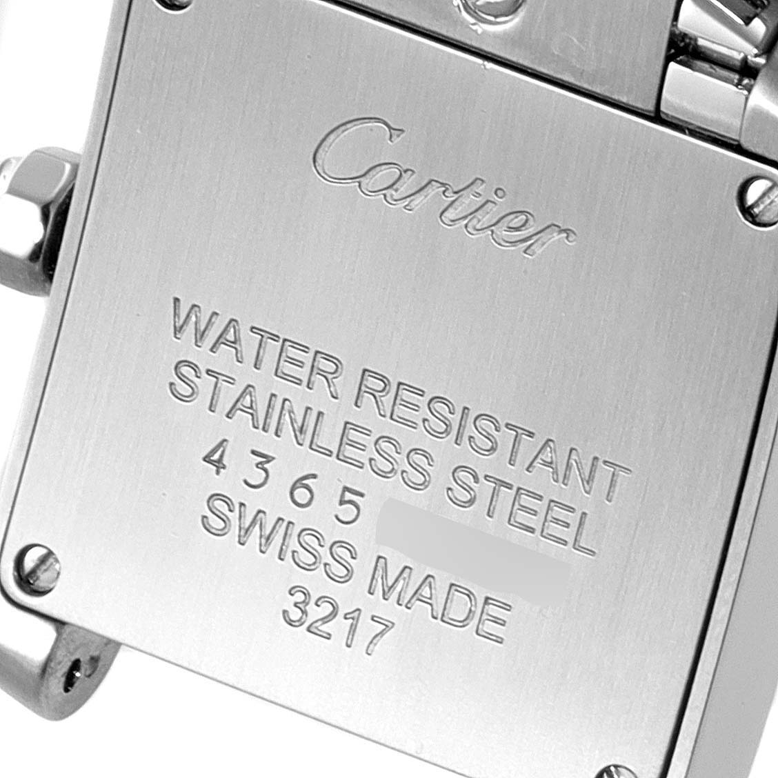 The image shows the back case of a Cartier Tank Francaise W51028Q Women's Stainless Steel Mother of Pearl Dial W51028Q Women's Stainless Steel Mother of Pearl Dial watch, engraved with water resistance, material, and model details.