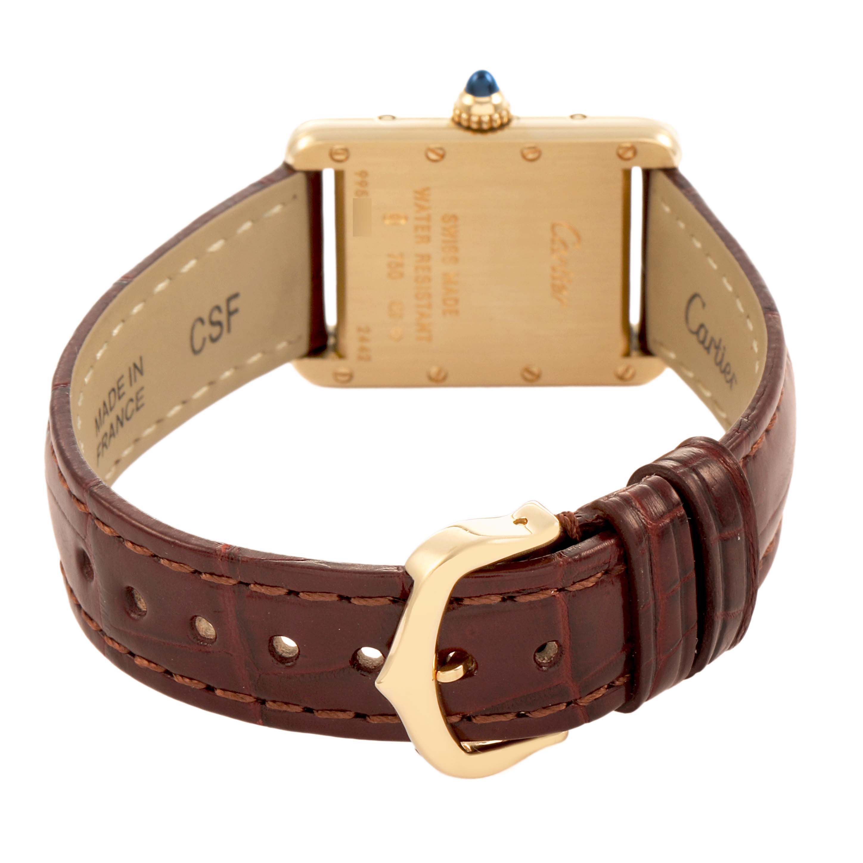 The image shows the back of the Cartier Tank Louis W1529856 Men's Yellow Gold Silver Dial watch, highlighting the case back, crown, and brown leather strap with buckle.