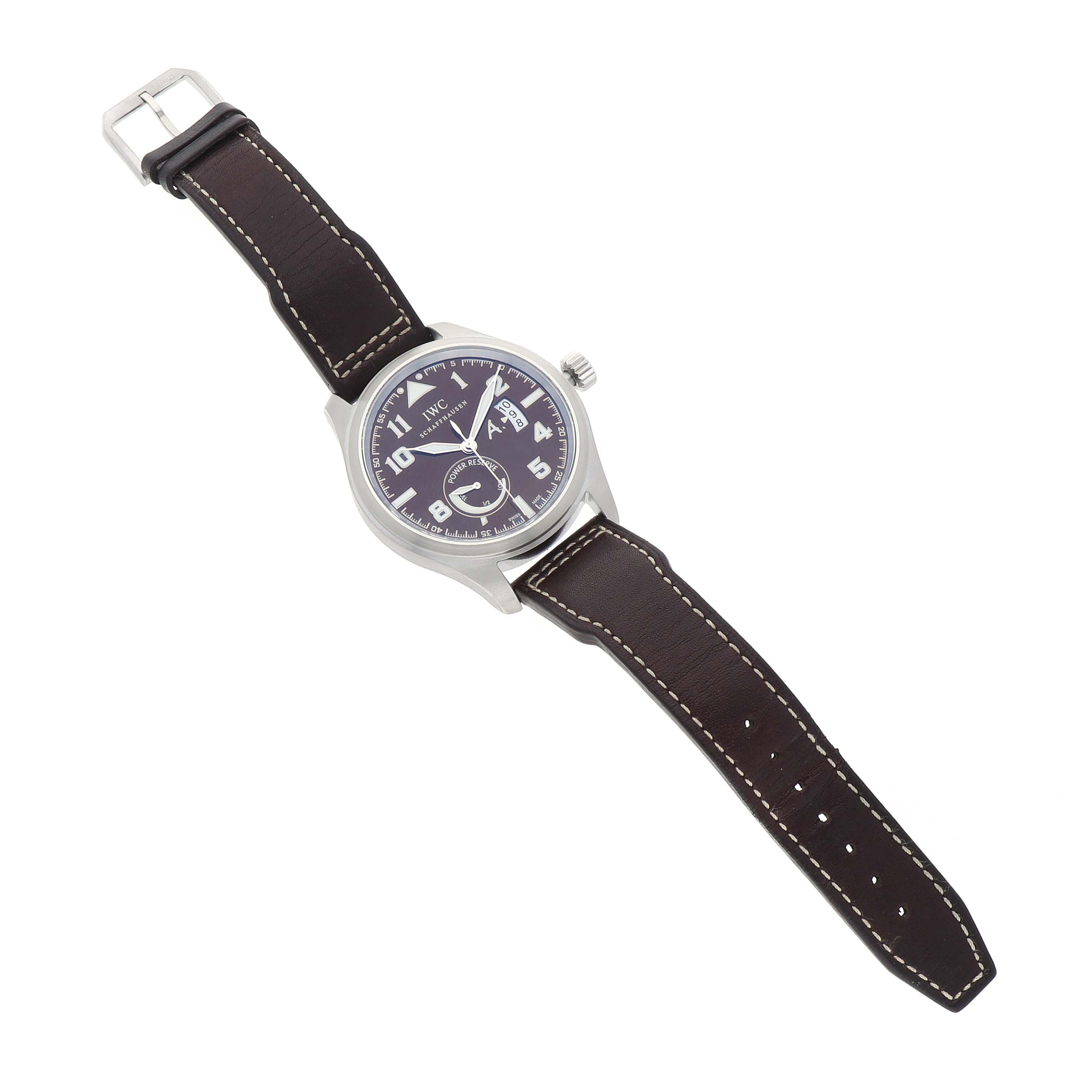 The IWC Pilot IW320104 Men's Stainless Steel Brown Dial watch is shown at a top-down angle, featuring its face, case, crown, and leather strap.