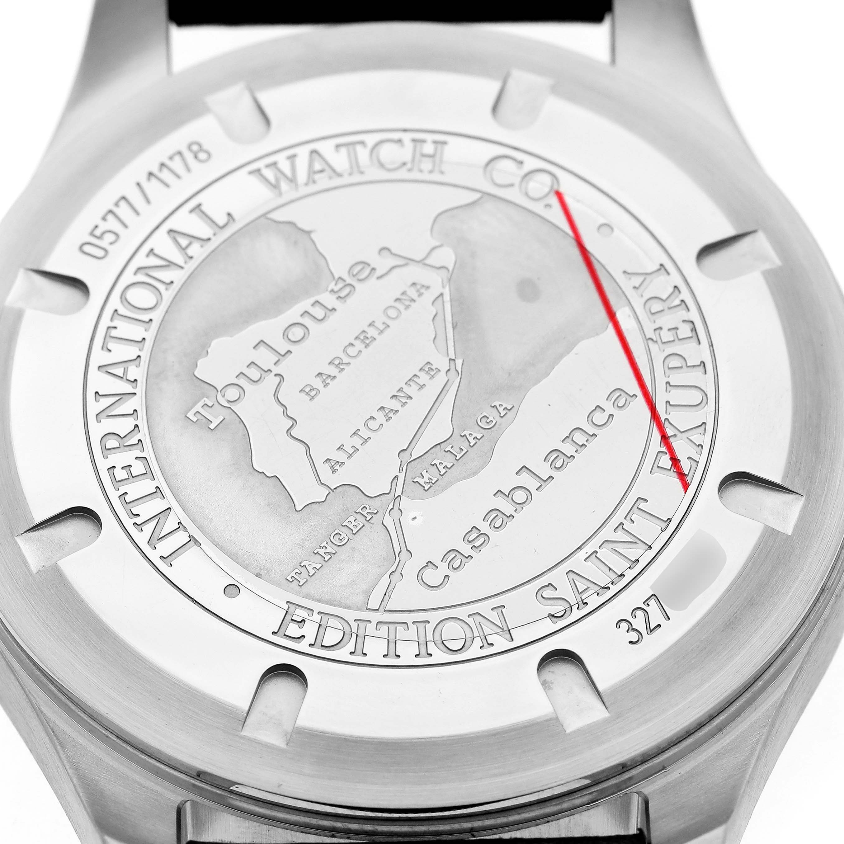 The image shows the case back of the IWC Pilot IW320104 Men's Stainless Steel Brown Dial model watch, featuring engraved text and a map design.