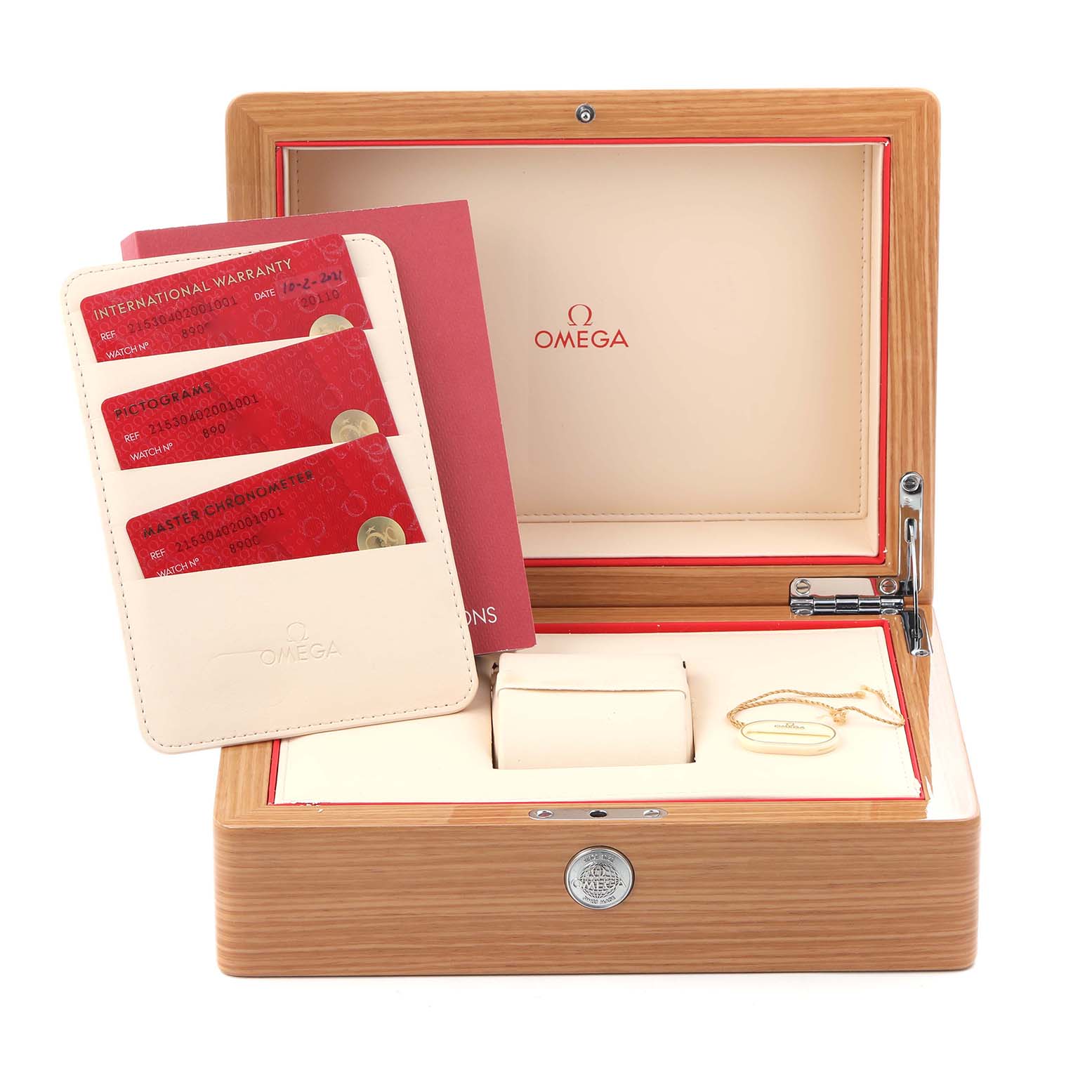 The image shows an open Omega watch box for the Planet Ocean model, featuring warranty cards and a small white pillow.