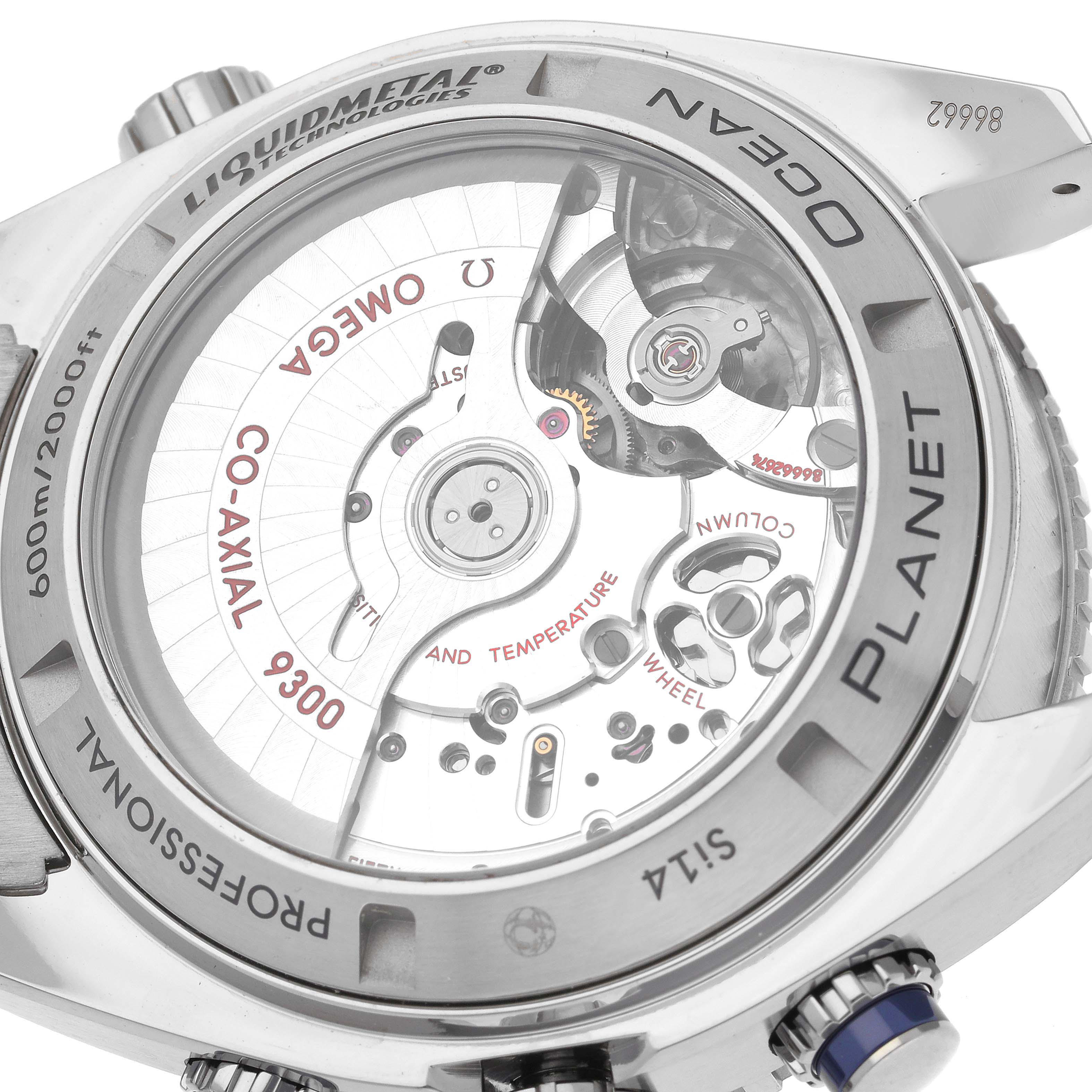 The image shows the back side of the Omega Planet Ocean 232.90.46.51.03.001 Men
s Titanium Blue Dial 232.90.46.51.03.001 Men
s Titanium Blue Dial watch, highlighting the movement, co-axial mechanism, and Liquidmetal technology.