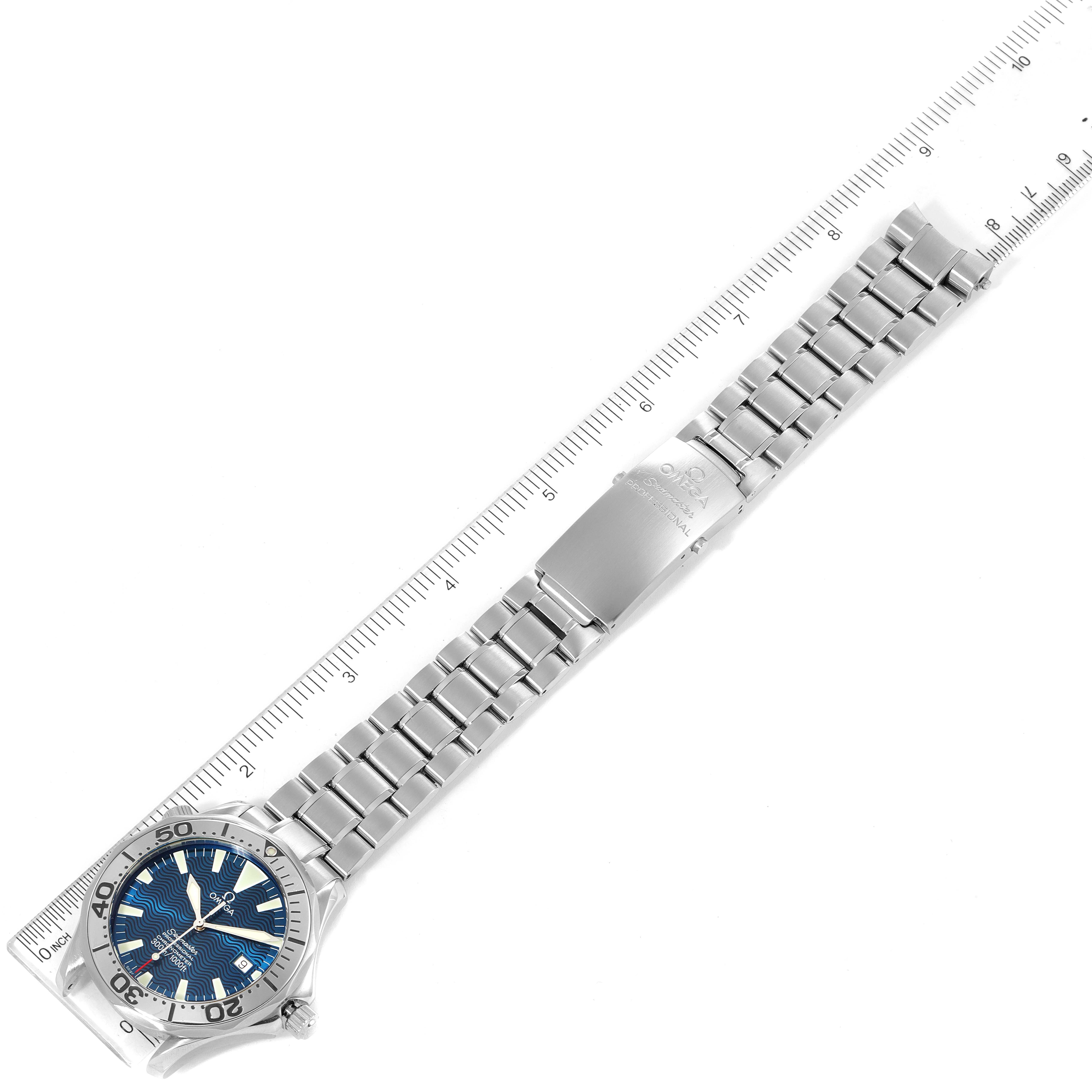 This Omega Seamaster 2255.80.00 Men
s Stainless Steel Blue Dial 2255.80.00 Men
s Stainless Steel Blue Dial watch is shown laid flat with the full bracelet and clasp visible next to a ruler for scale.