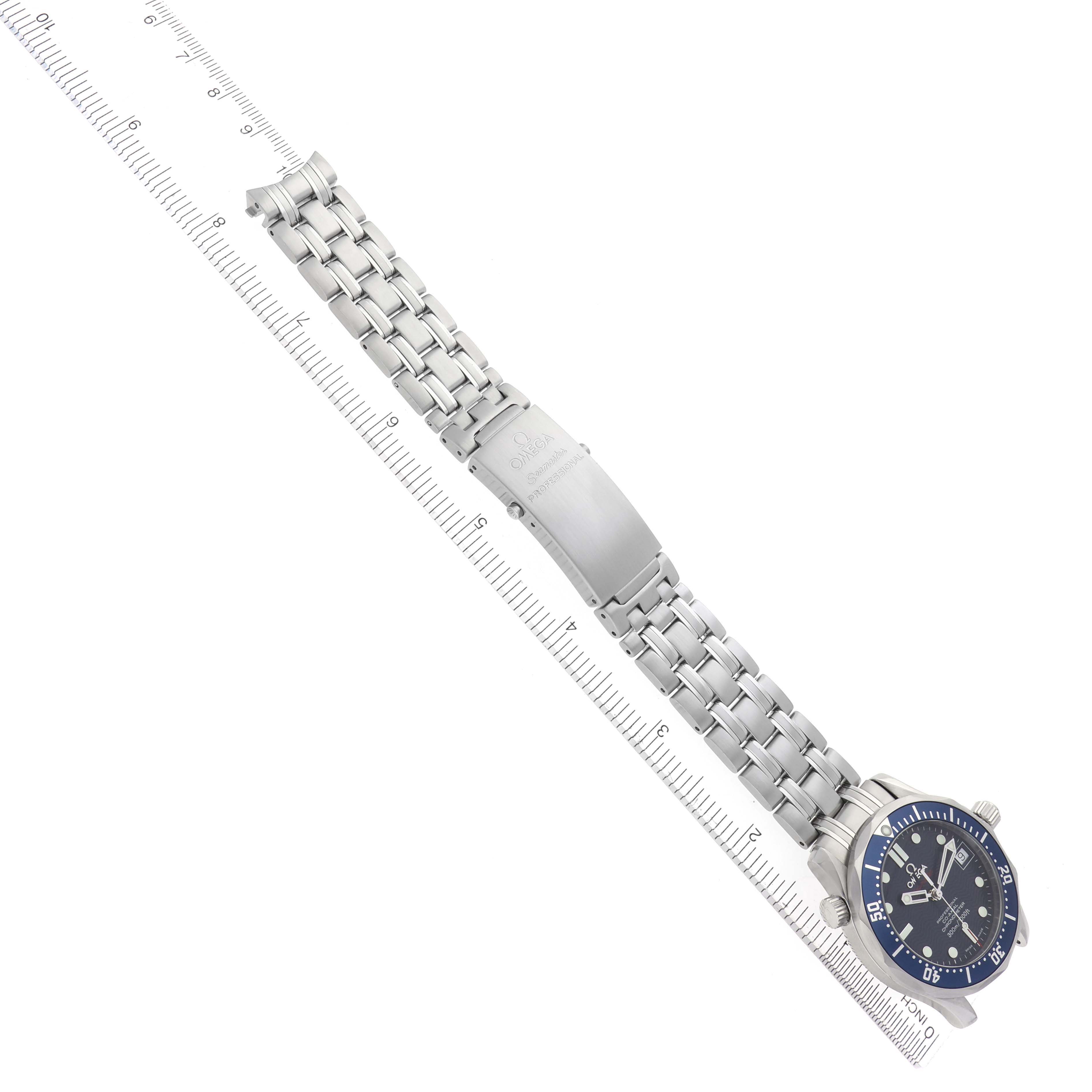 The Omega Seamaster 2222.80.00 Men
s Stainless Steel Blue Dial 2222.80.00 Men
s Stainless Steel Blue Dial watch is shown at a slight angle displaying the bracelet, clasp, and dial next to a ruler for scale.