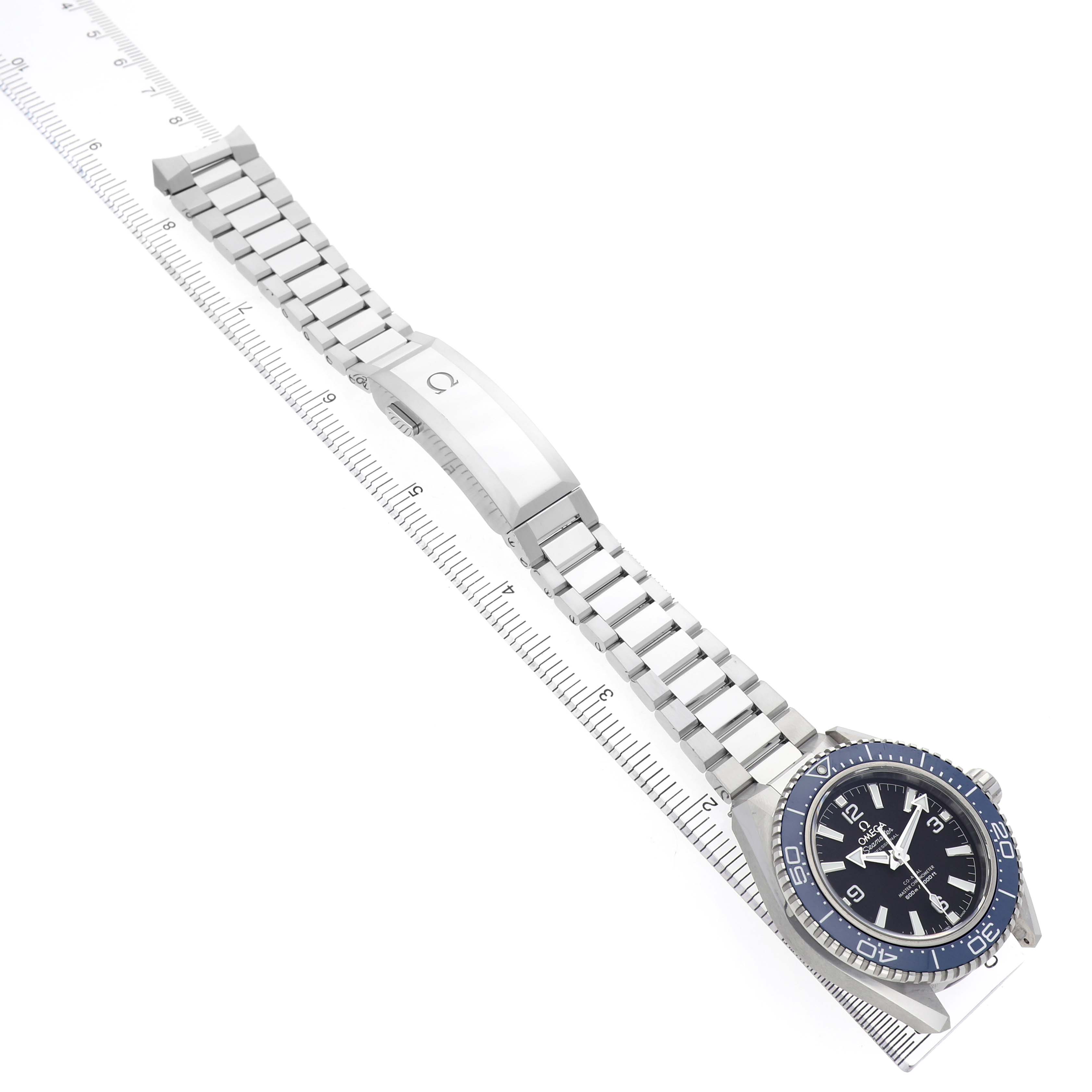 The Omega Planet Ocean 217.30.42.21.01.002 Men's Stainless Steel Black Dial watch is shown at a top-down angle, highlighting the face, bezel, bracelet, and clasp.