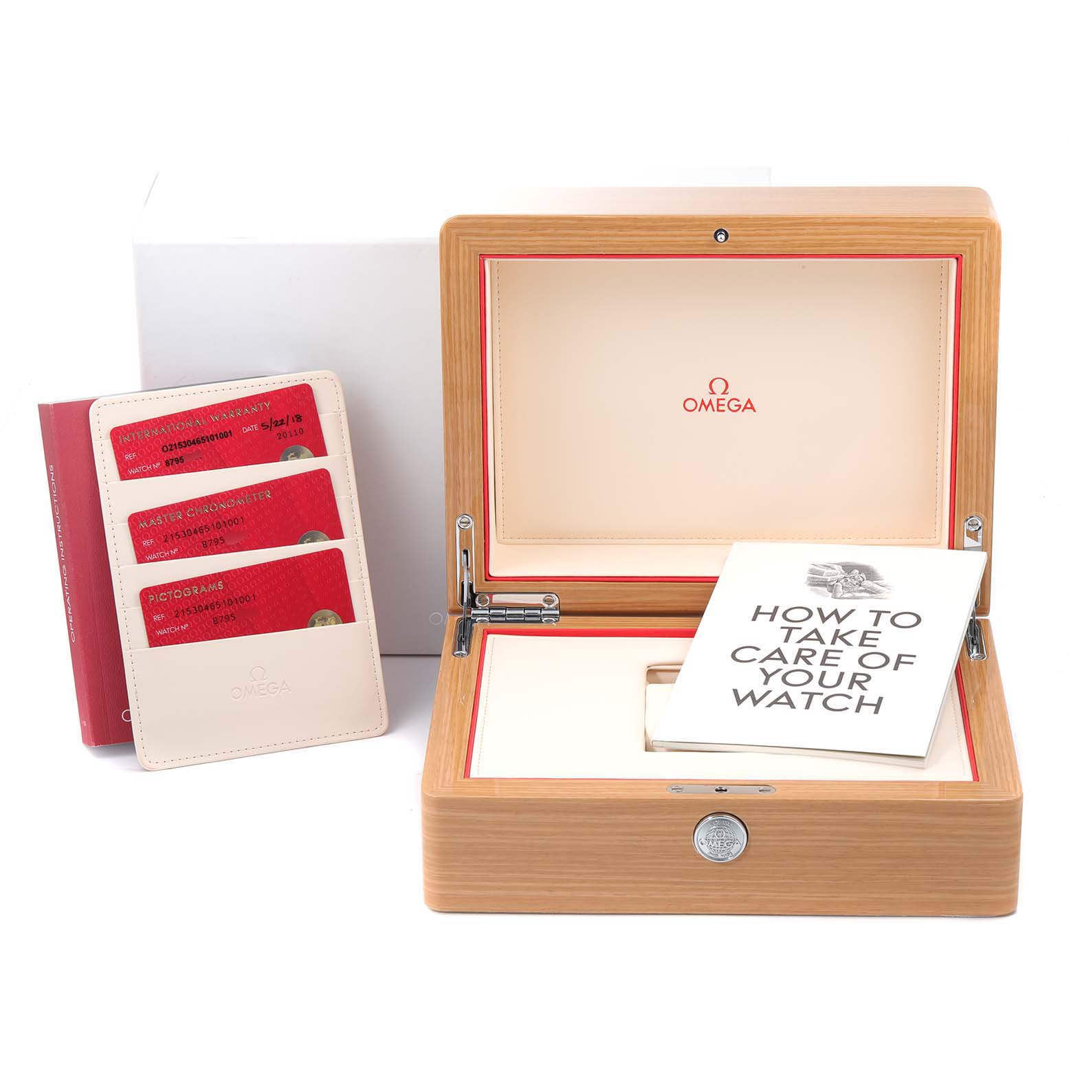 The image shows the Omega Planet Ocean 215.30.46.51.01.001 Men
s Stainless Steel Black Dial 215.30.46.51.01.001 Men
s Stainless Steel Black Dial watch box, warranty cards, and an instruction manual from a frontal angle.