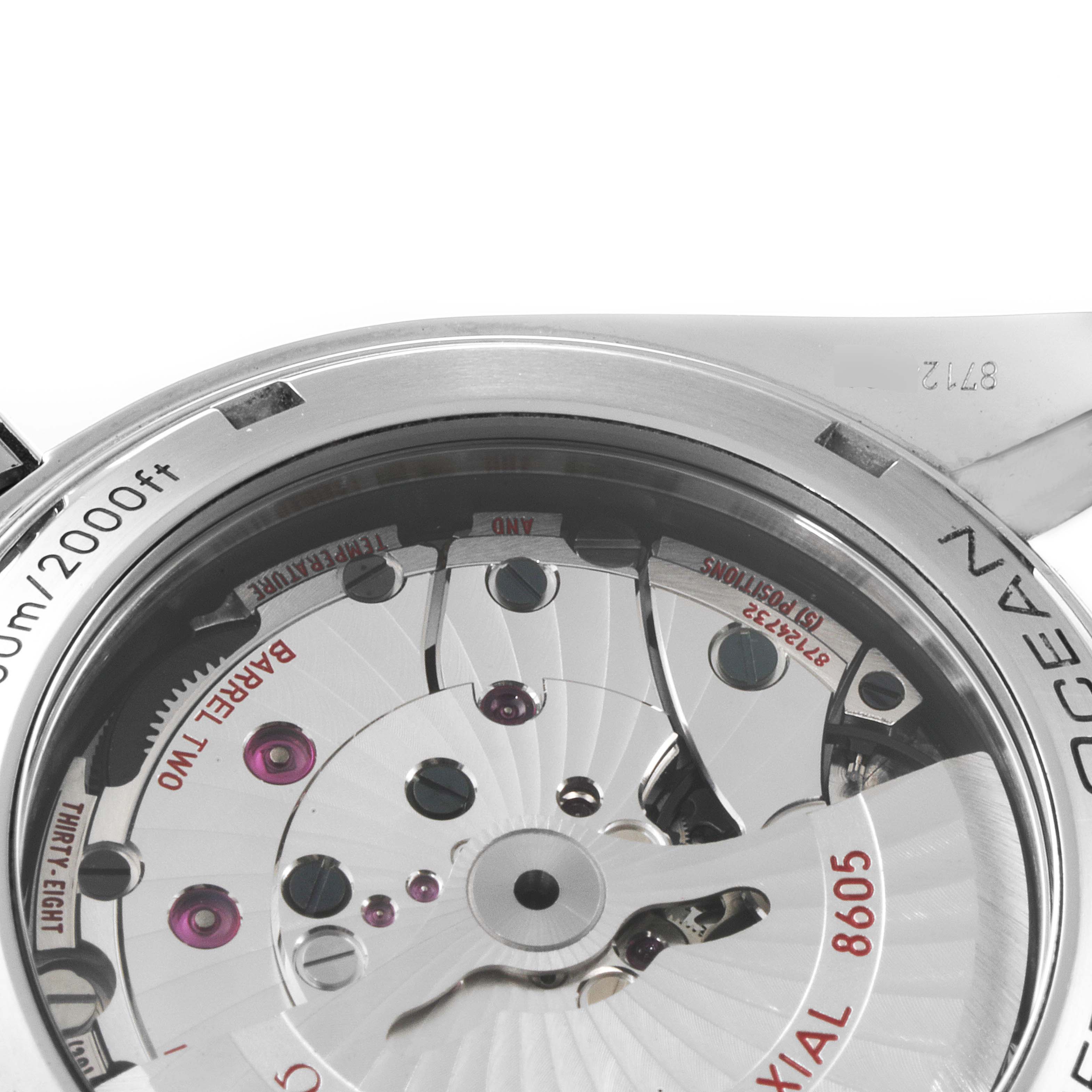 The image shows the back of the Omega Planet Ocean 232.30.44.22.01.001 Men
s Stainless Steel Black Dial 232.30.44.22.01.001 Men
s Stainless Steel Black Dial watch, highlighting its movement and internal mechanism.