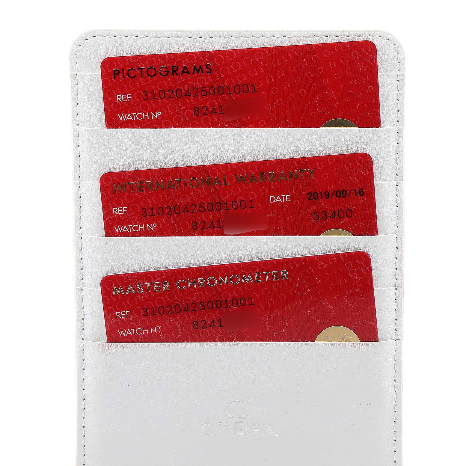 The image shows warranty cards for an Omega Speedmaster 310.20.42.50.01.001 Men's Stainless Steel Grey Dial 310.20.42.50.01.001 Men's Stainless Steel Grey Dial watch placed in a white cardholder.