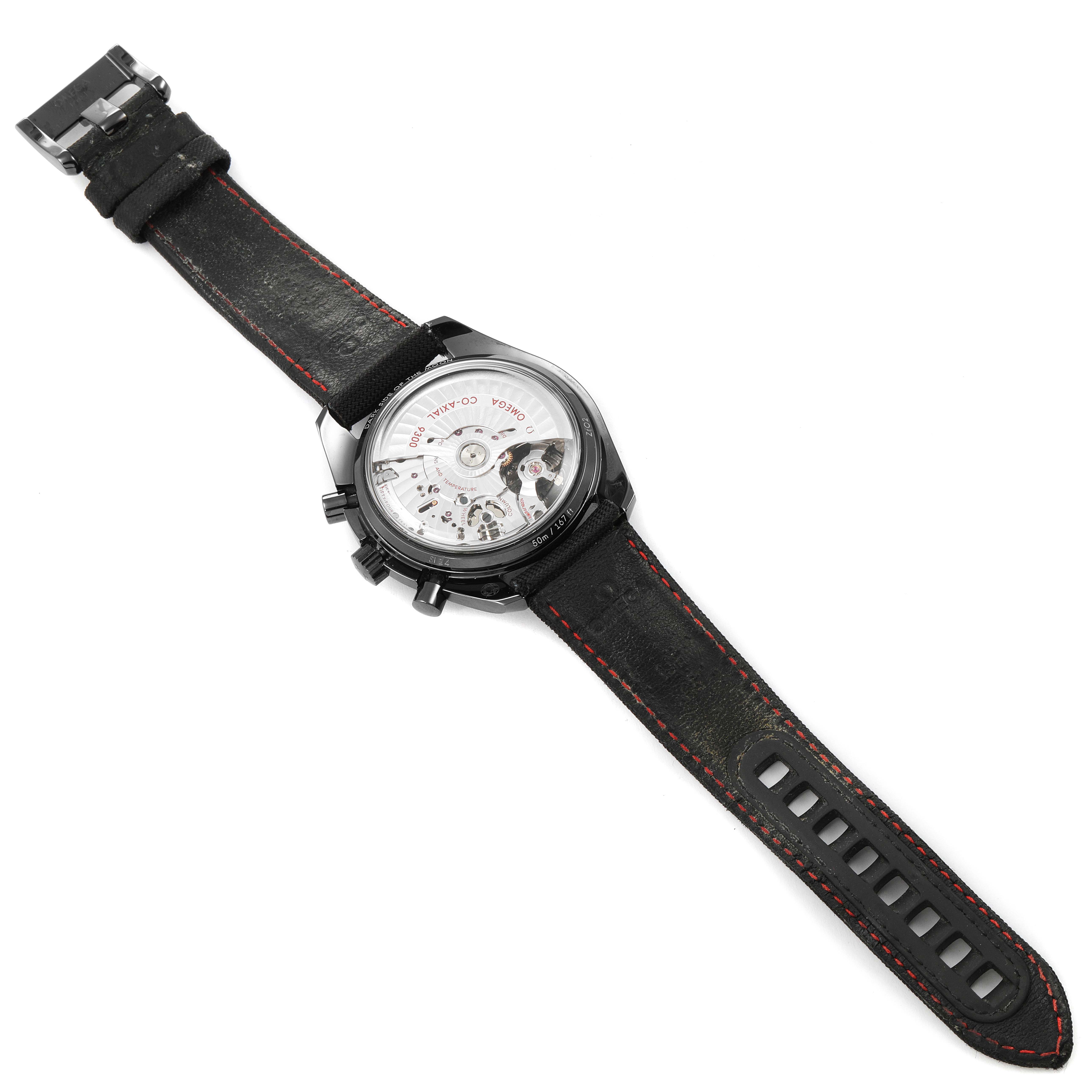 The image shows the rear view of an Omega Speedmaster 311.92.44.51.01.003 Men's Ceramic Black Dial 311.92.44.51.01.003 Men's Ceramic Black Dial watch, highlighting its open case back and leather strap with red stitching.