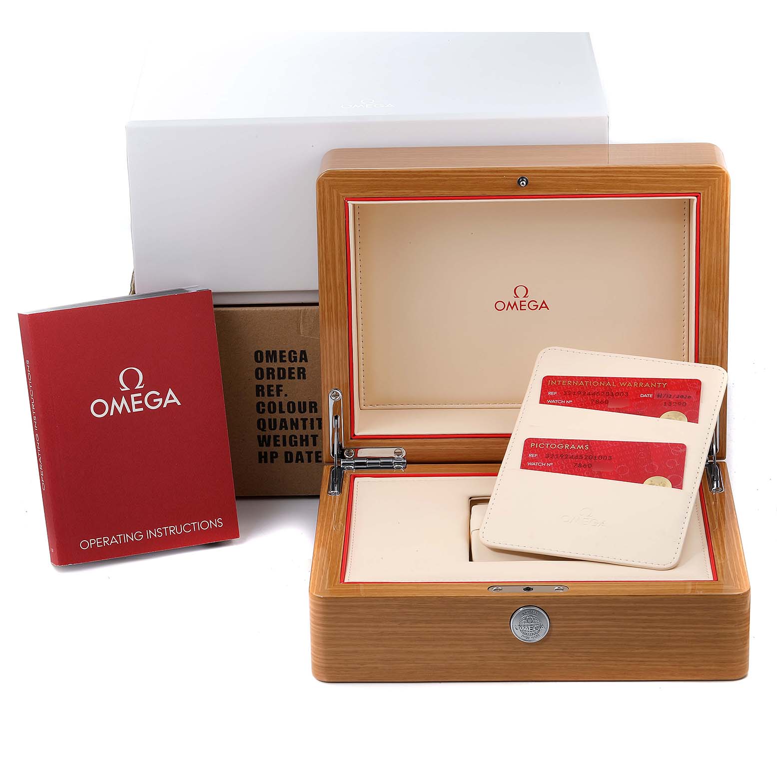 The image shows the box, warranty cards, and operating instructions for an Omega Speedmaster 321.92.44.52.01.003 Men's Titanium Black Dial 321.92.44.52.01.003 Men's Titanium Black Dial watch in an open presentation box.