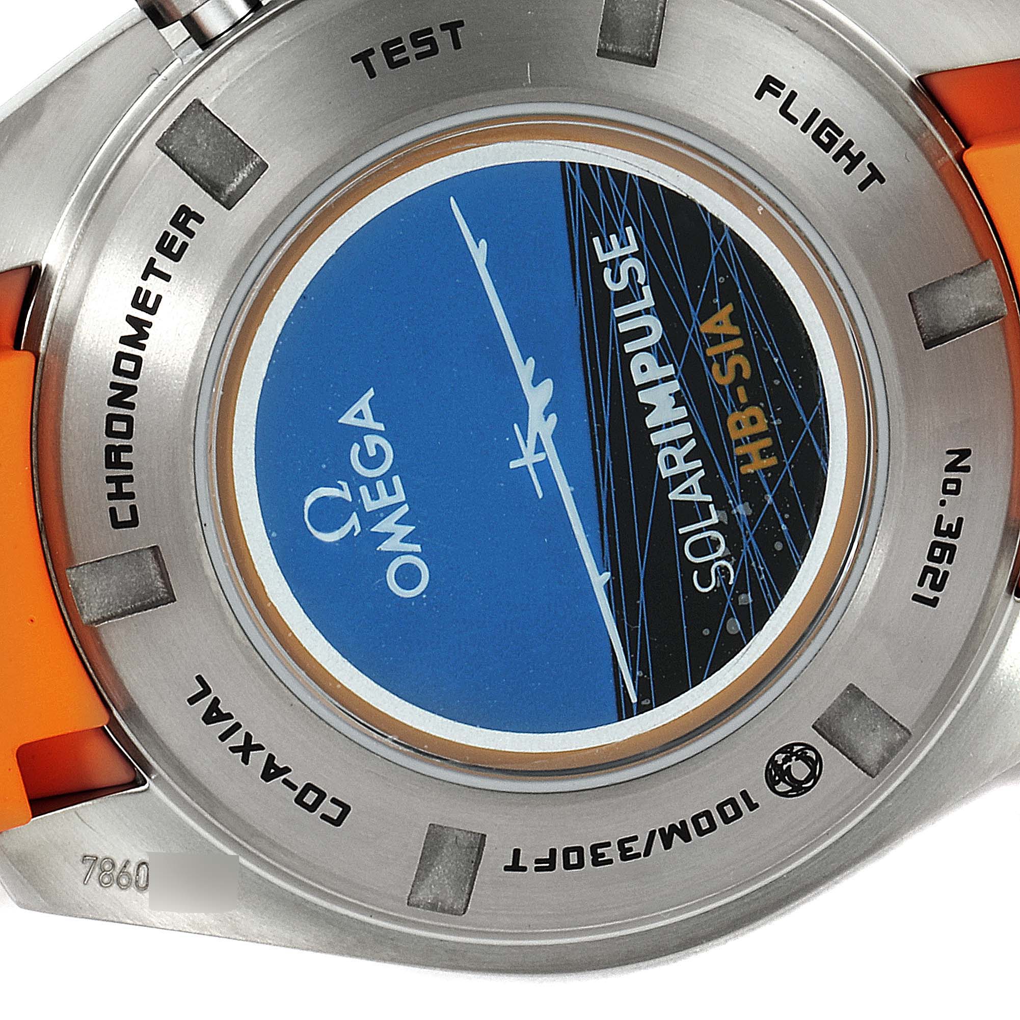 This image shows the back of the Omega Speedmaster 321.92.44.52.01.003 Men's Titanium Black Dial 321.92.44.52.01.003 Men's Titanium Black Dial watch, featuring the "Solar Impulse" information and part of the orange strap.