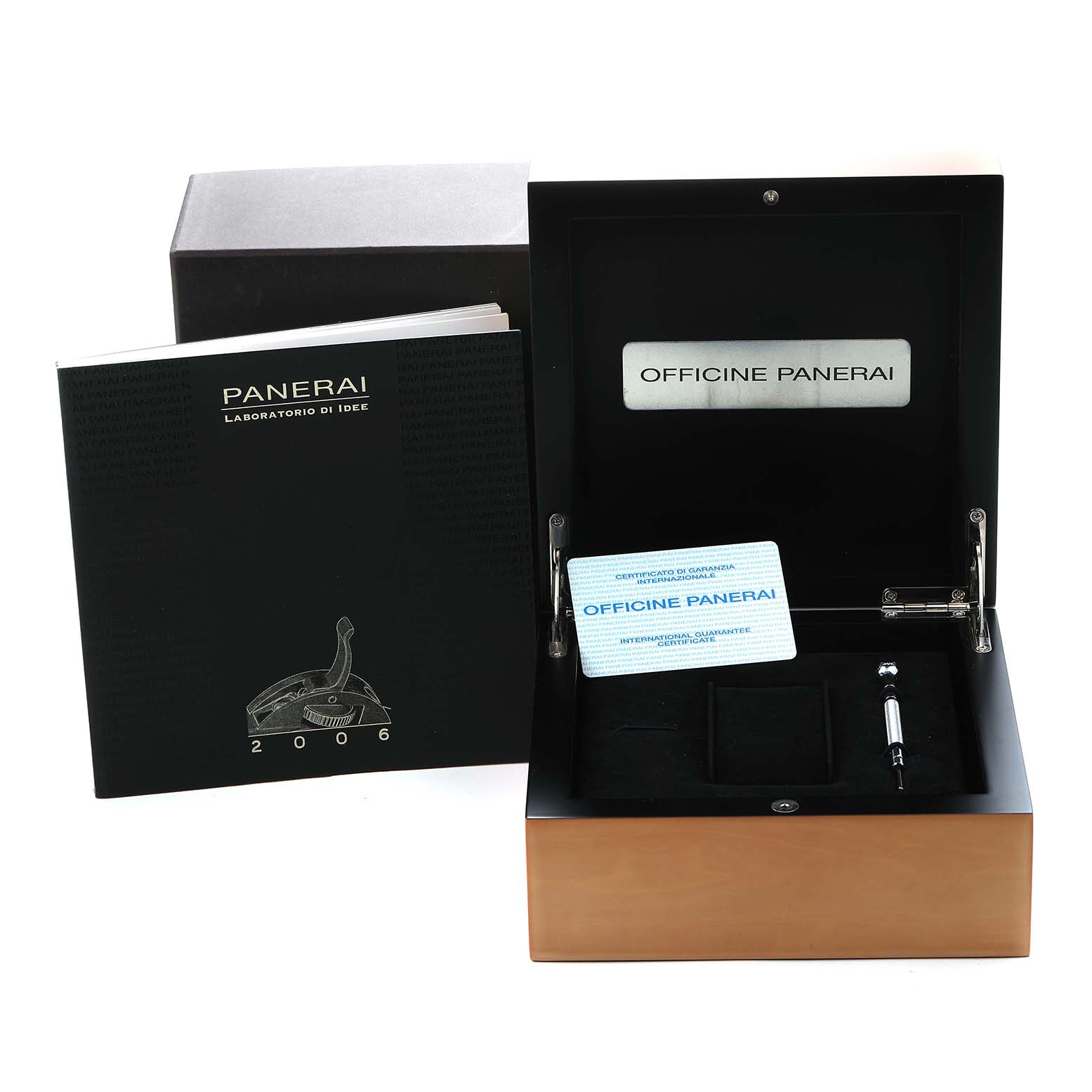 The image shows a Panerai Luminor PAM00088 Men
s Stainless Steel Black Dial PAM00088 Men
s Stainless Steel Black Dial box and accessories, including a booklet, guarantee card, and a tool, viewed from the top.