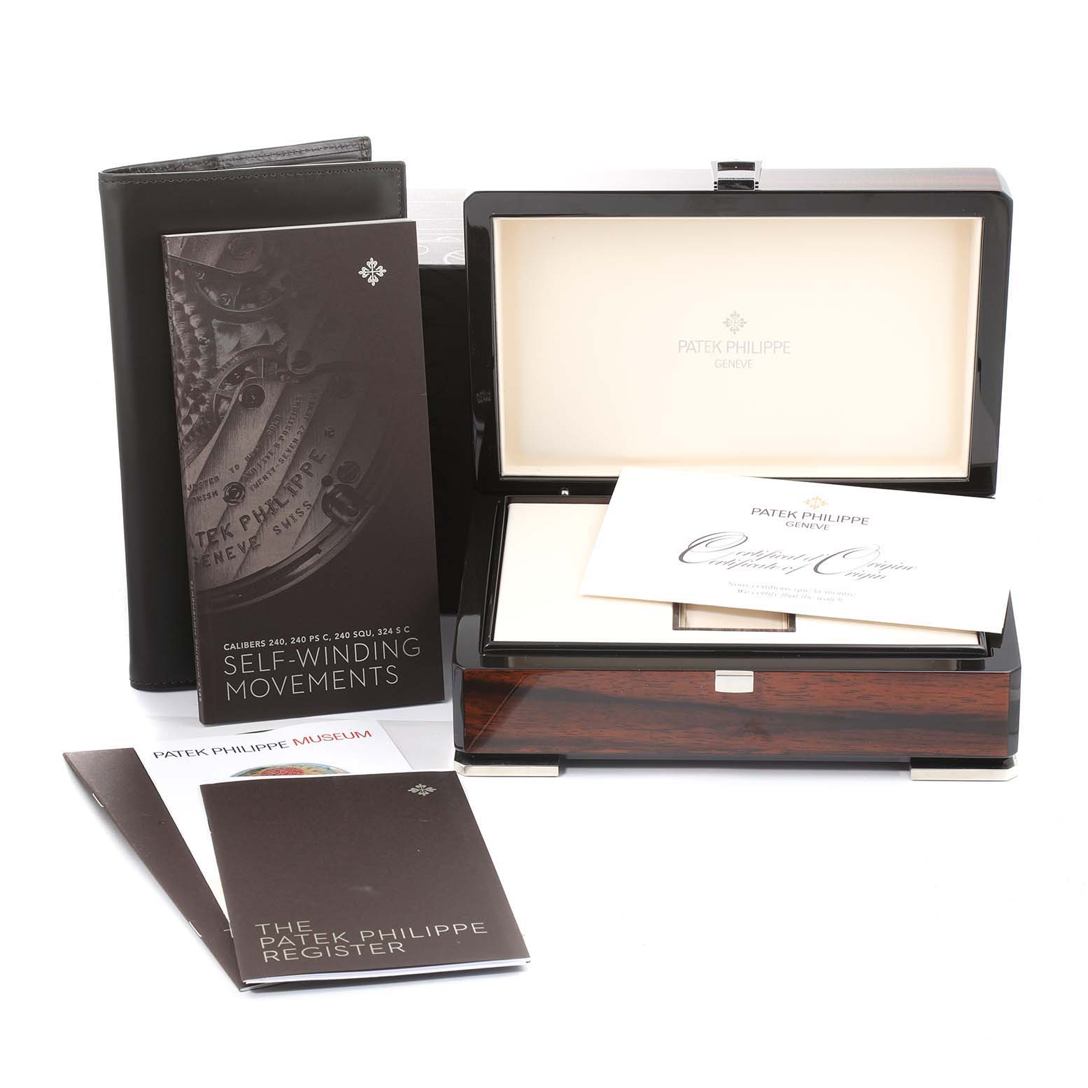 The image shows a Patek Philippe Calatrava 5296R-010 Men
s Rose Gold Silver Dial 5296R-010 Men
s Rose Gold Silver Dial watch box and various booklets at a front angle.