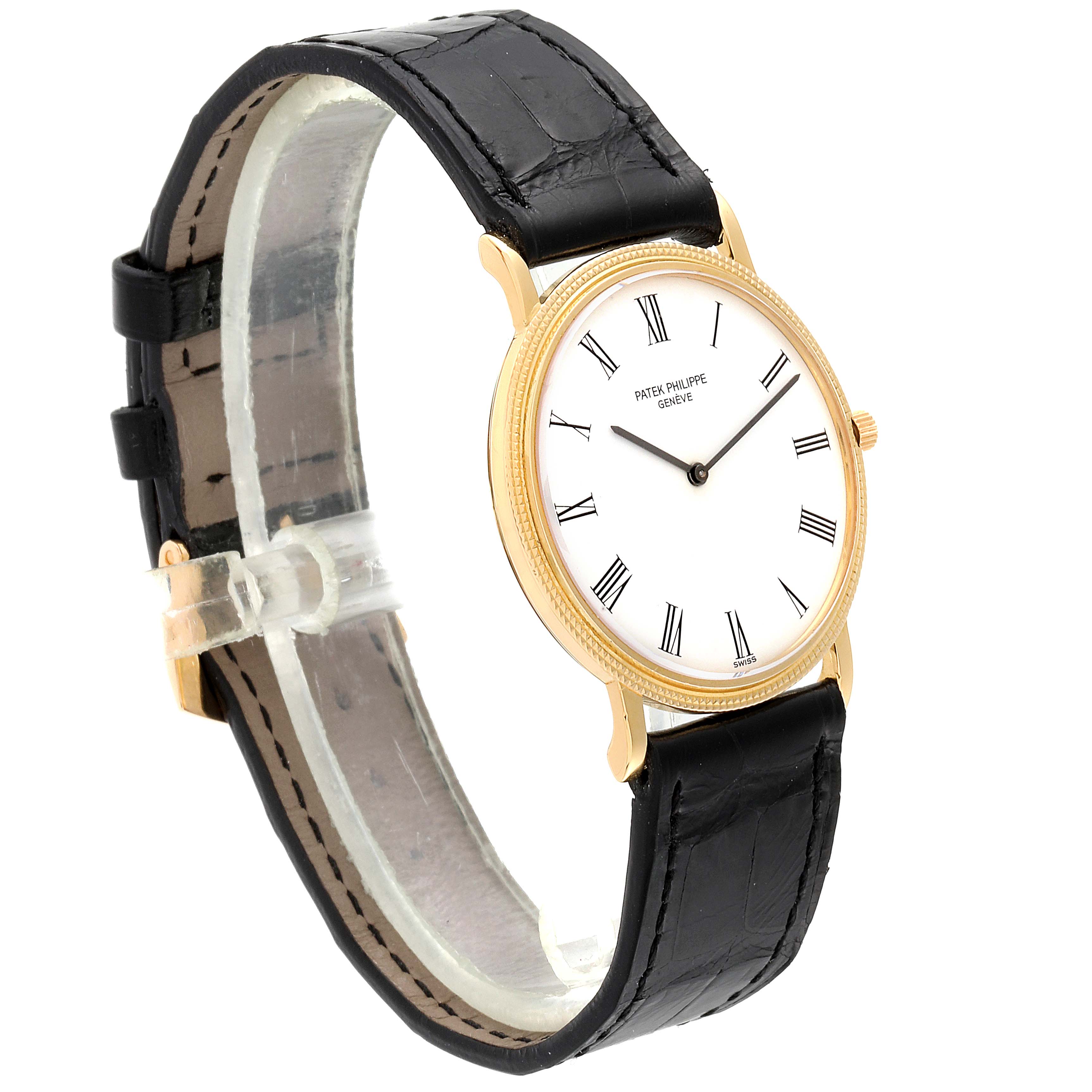 This image shows a Patek Philippe Calatrava 3520 Men's Yellow Gold White Dial 3520 Men's Yellow Gold White Dial watch at a three-quarter angle, highlighting its black strap and gold case with a white dial.