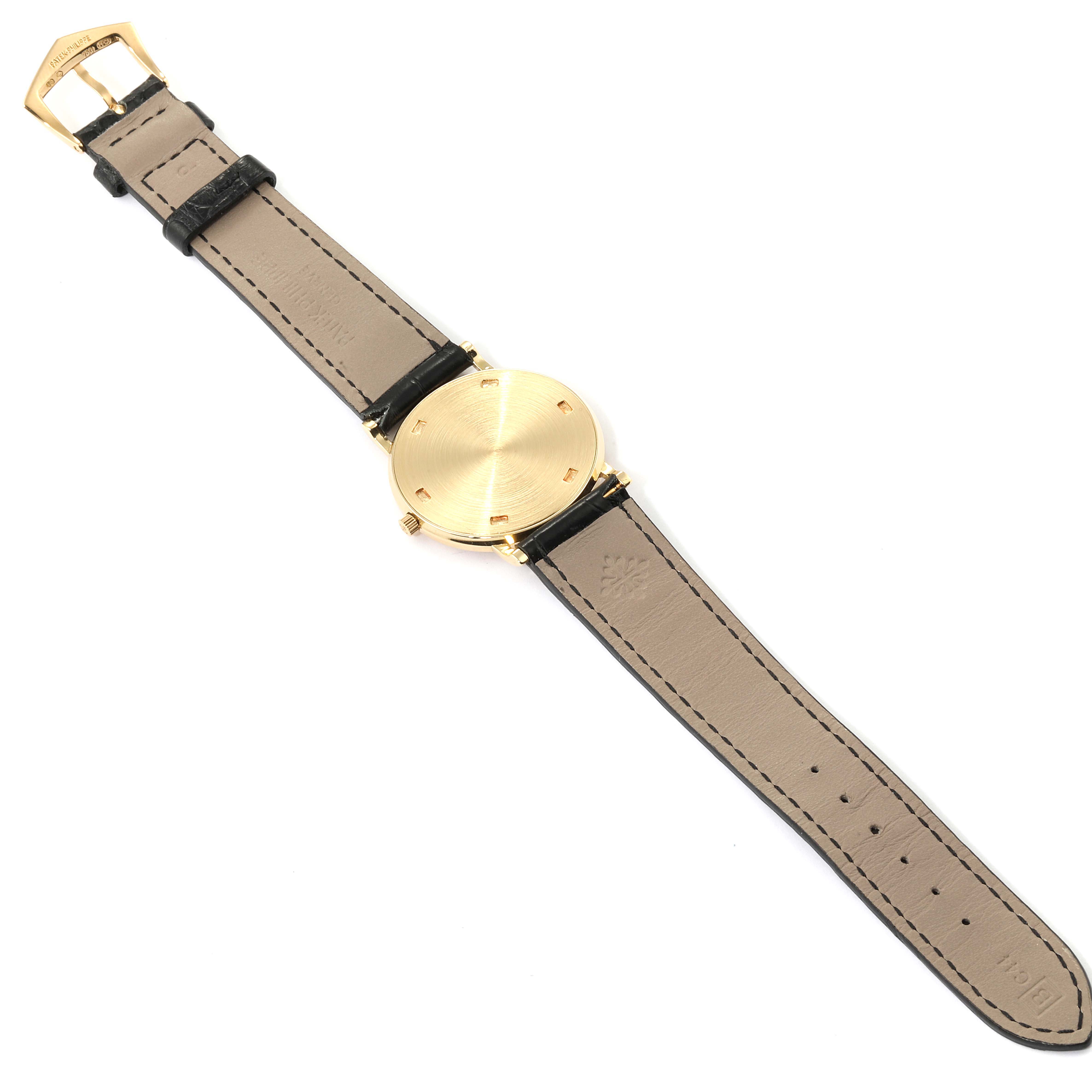 The image shows the back and strap of a Patek Philippe Calatrava 3520 Men's Yellow Gold White Dial 3520 Men's Yellow Gold White Dial watch laid flat.