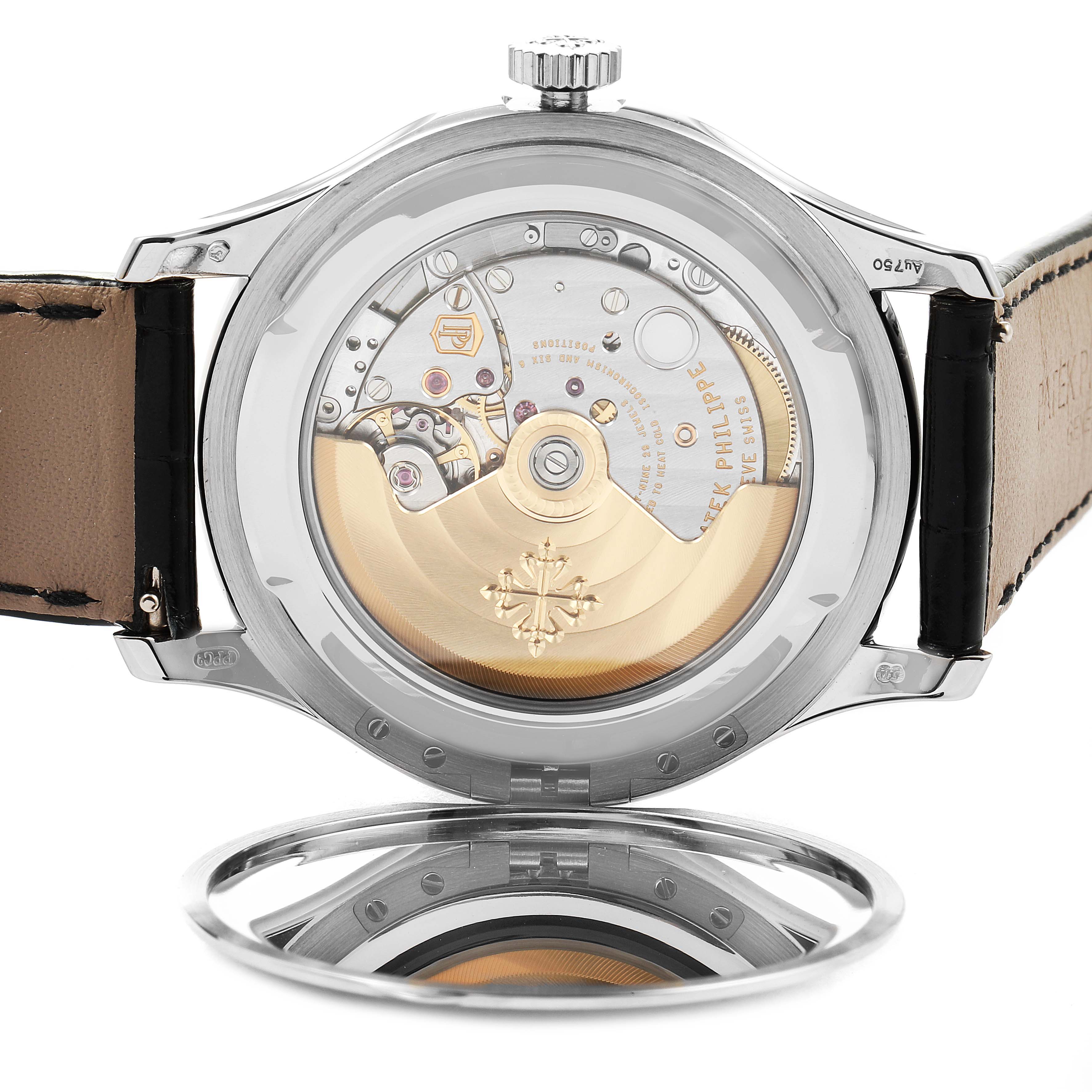 The image shows the case back of the Patek Philippe Calatrava 5227G Men
s White Gold Black Dial 5227G Men
s White Gold Black Dial, revealing its intricate mechanical movement.