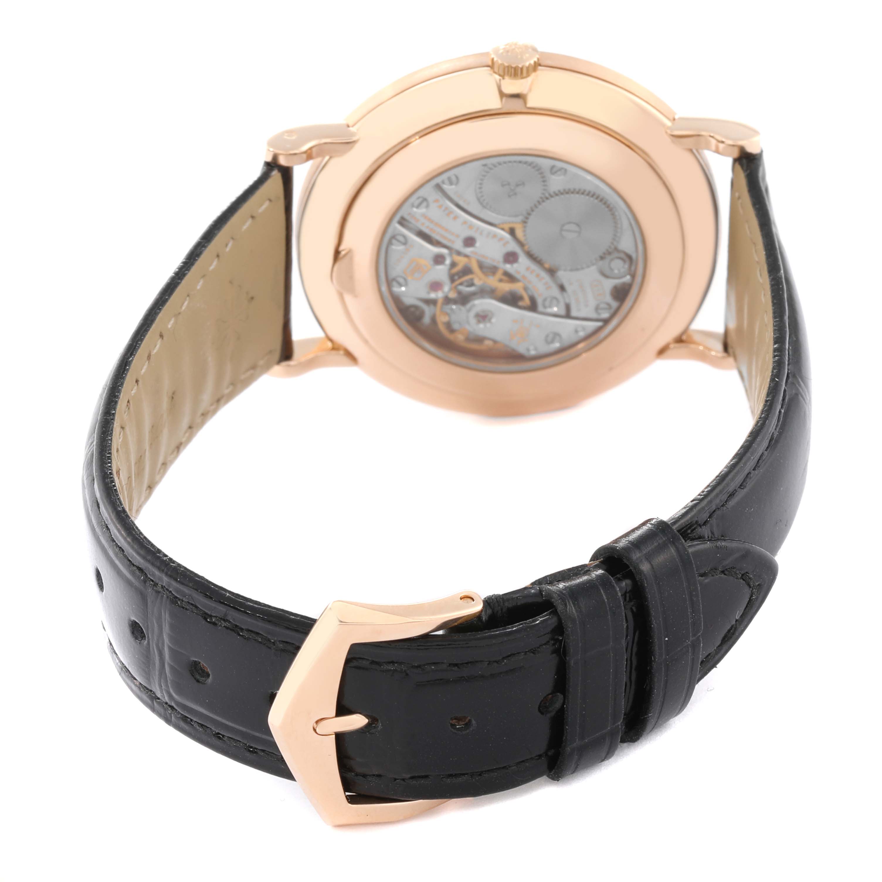 This image shows the back view of a Patek Philippe Calatrava 5119R Men's Rose Gold White Dial 5119R Men's Rose Gold White Dial watch, highlighting its movement and black leather strap.