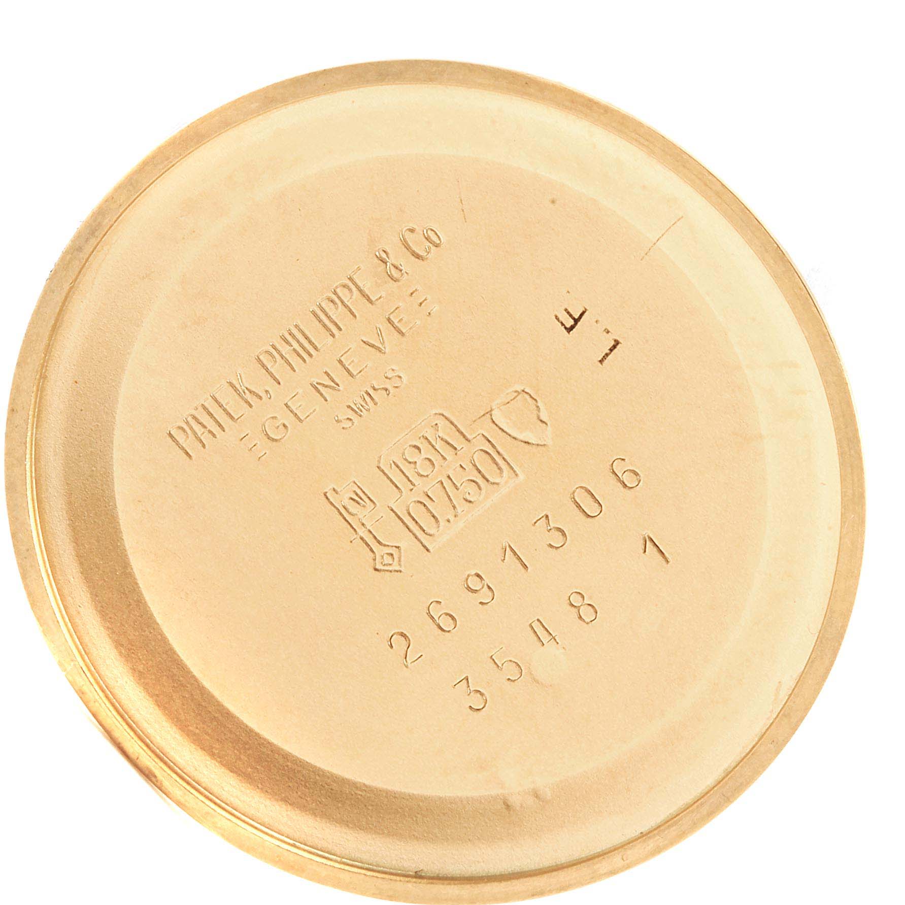 This image shows the interior case back of a Patek Philippe Golden Ellipse 3548 Women
s Yellow Gold Blue Dial 3548 Women
s Yellow Gold Blue Dial watch with various engravings.