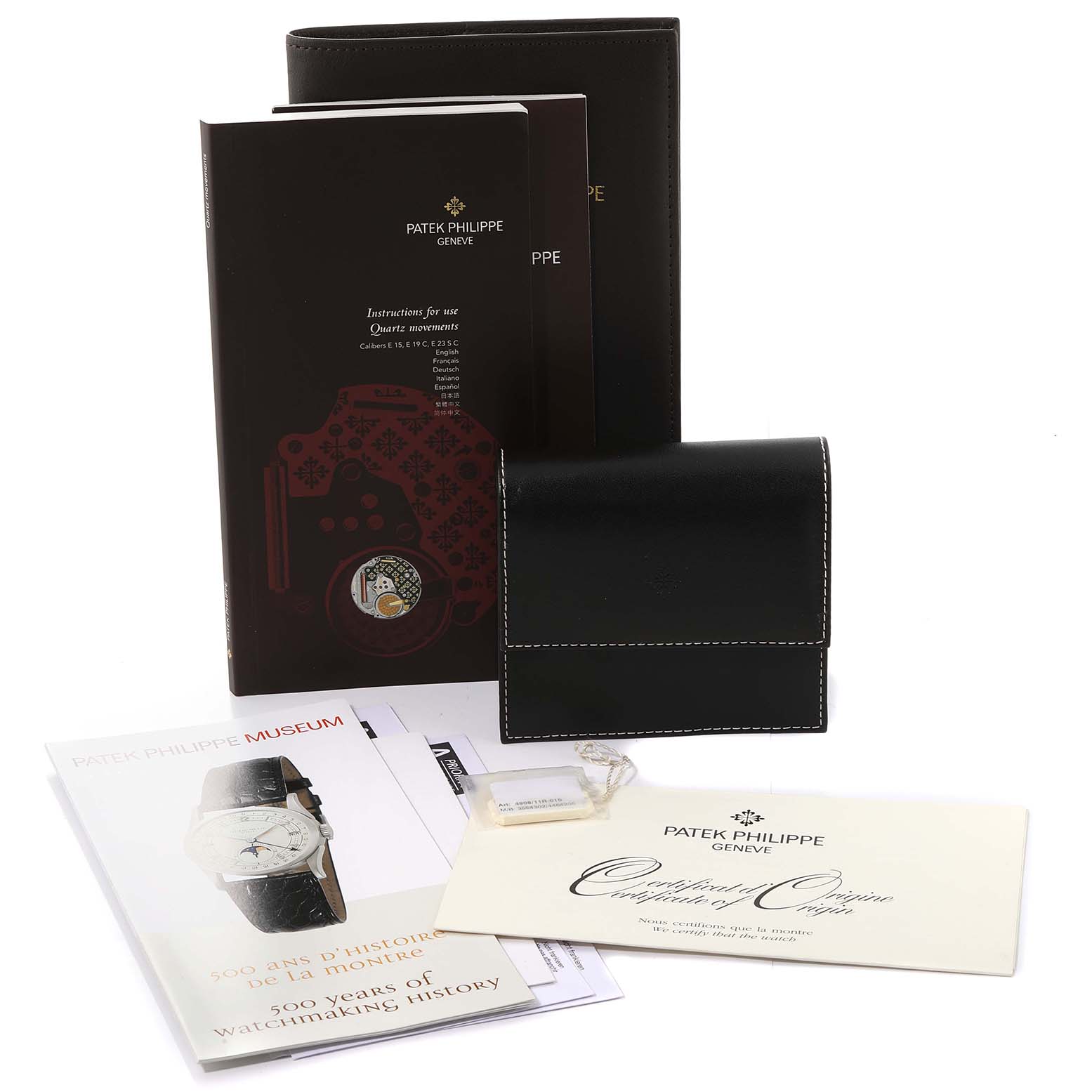 Accessories for the Patek Philippe Twenty-4 4908/11R-010 Women's Rose Gold Brown Dial 4908/11R-010 Women's Rose Gold Brown Dial model, including booklets, certificates, and a black leather pouch.
