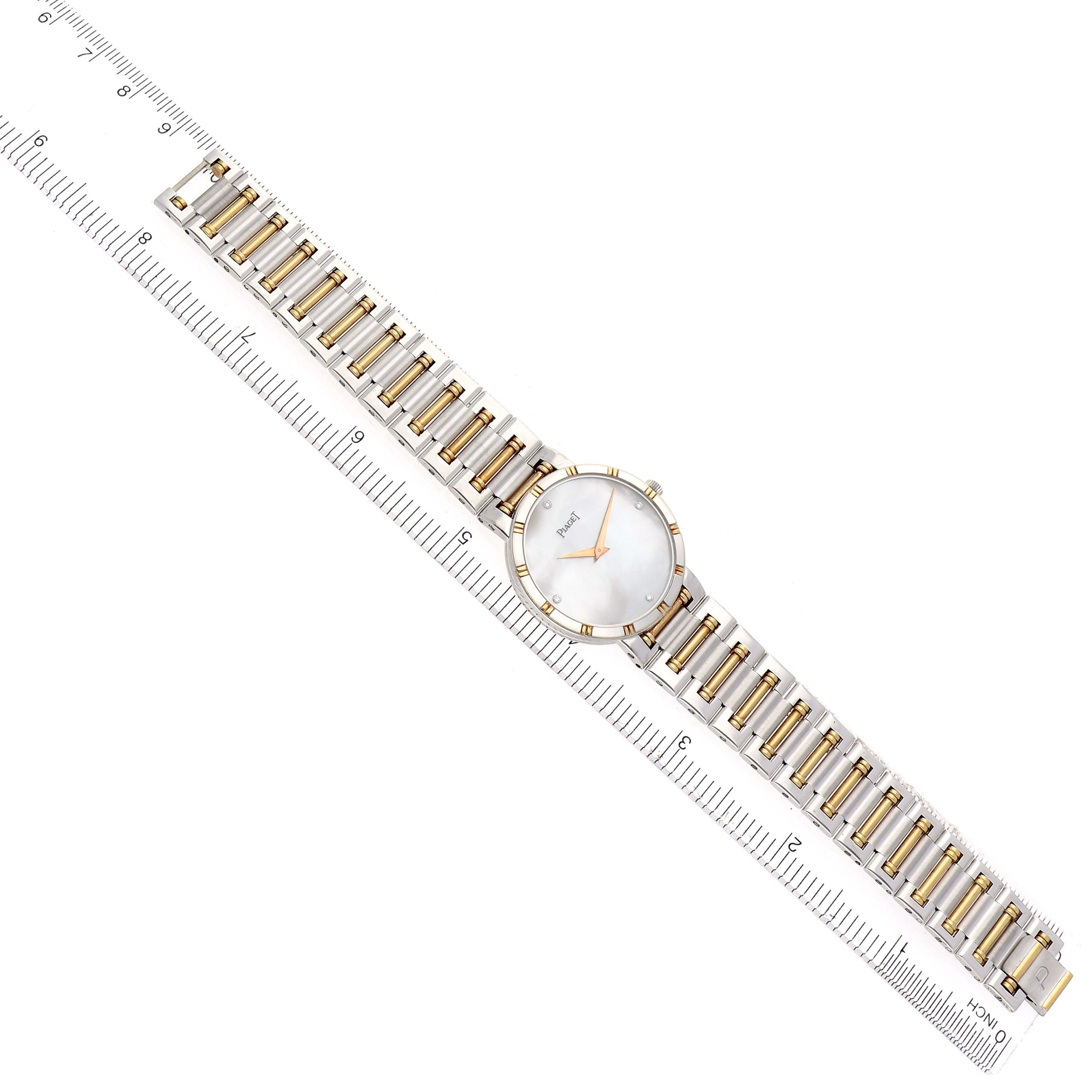 The Piaget 94023K81 Women
s Steel and Gold (two tone) Mother of Pearl Dial 94023K81 Women
s Steel and Gold (two tone) Mother of Pearl Dial Dancer Midsize Steel Yellow Gold MOP Diamond Ladies Watch is shown from a top-down angle, highlighting the face and bracelet.