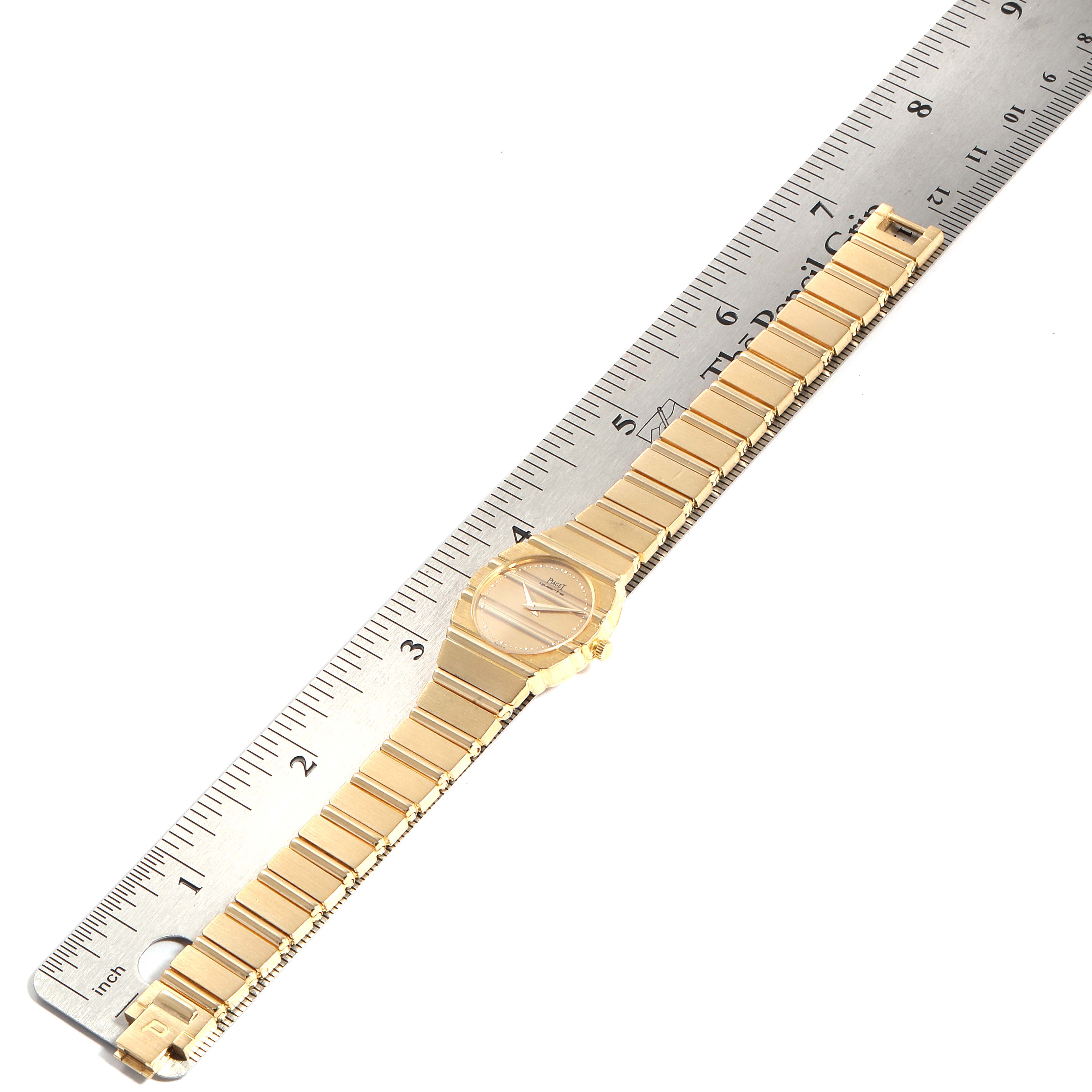 The image shows a top-down view of the Piaget 861 C701 Women's Yellow Gold Champagne Dial 861 C701 Women's Yellow Gold Champagne Dial Polo 18K Yellow Gold Champagne Dial Quartz Ladies Watch C701 with a ruler for scale.