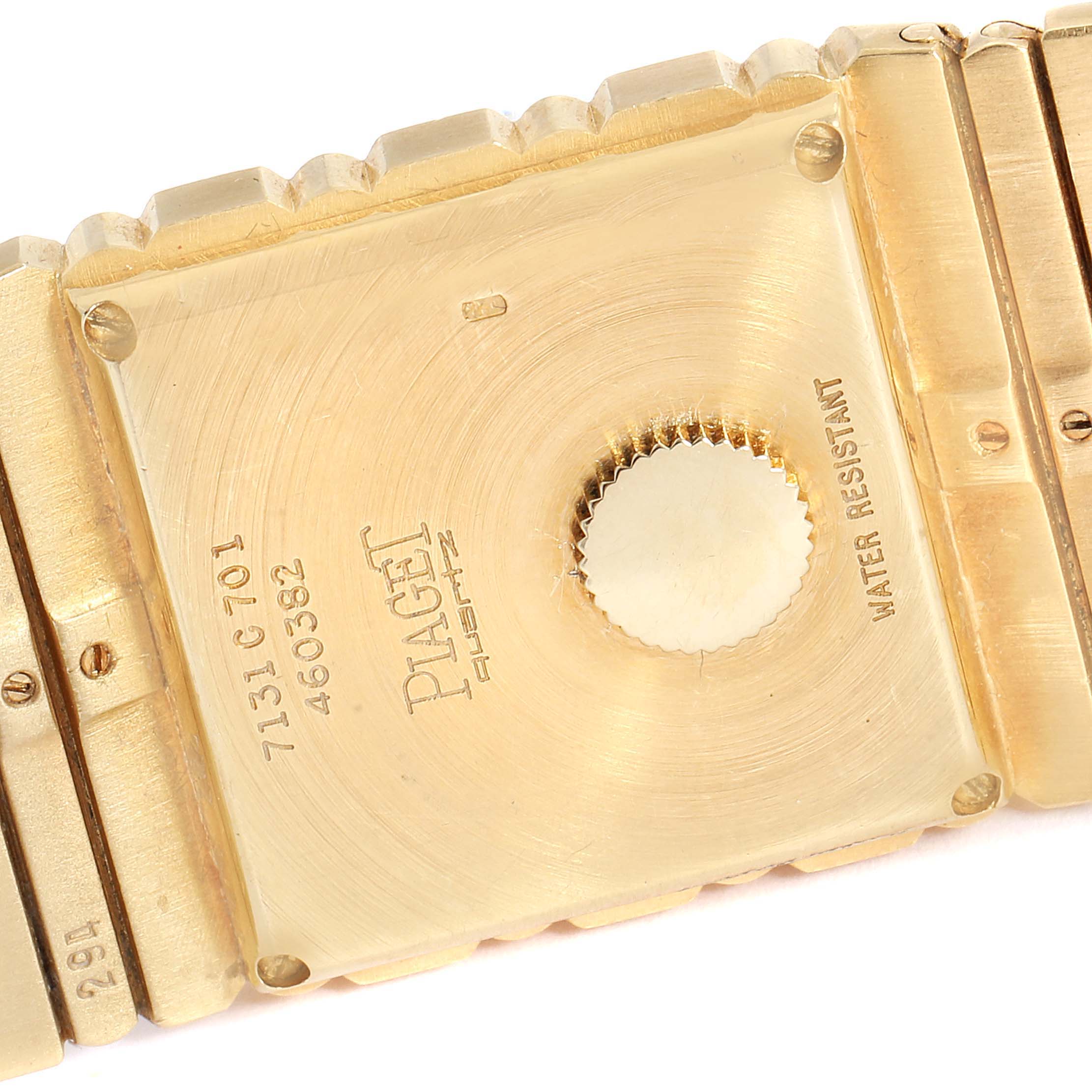 The image shows the back case of a Piaget 7131 C701 Men's Yellow Gold Champagne Dial 7131 C701 Men's Yellow Gold Champagne Dial Polo 18K Yellow Gold Quartz Men's Watch 7131 model, highlighting the engraved details and crown.