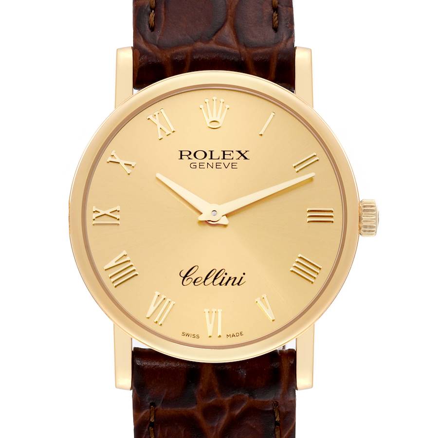 The image shows a front view of a Rolex Cellini watch, highlighting its gold dial, Roman numeral markers, and brown leather strap.