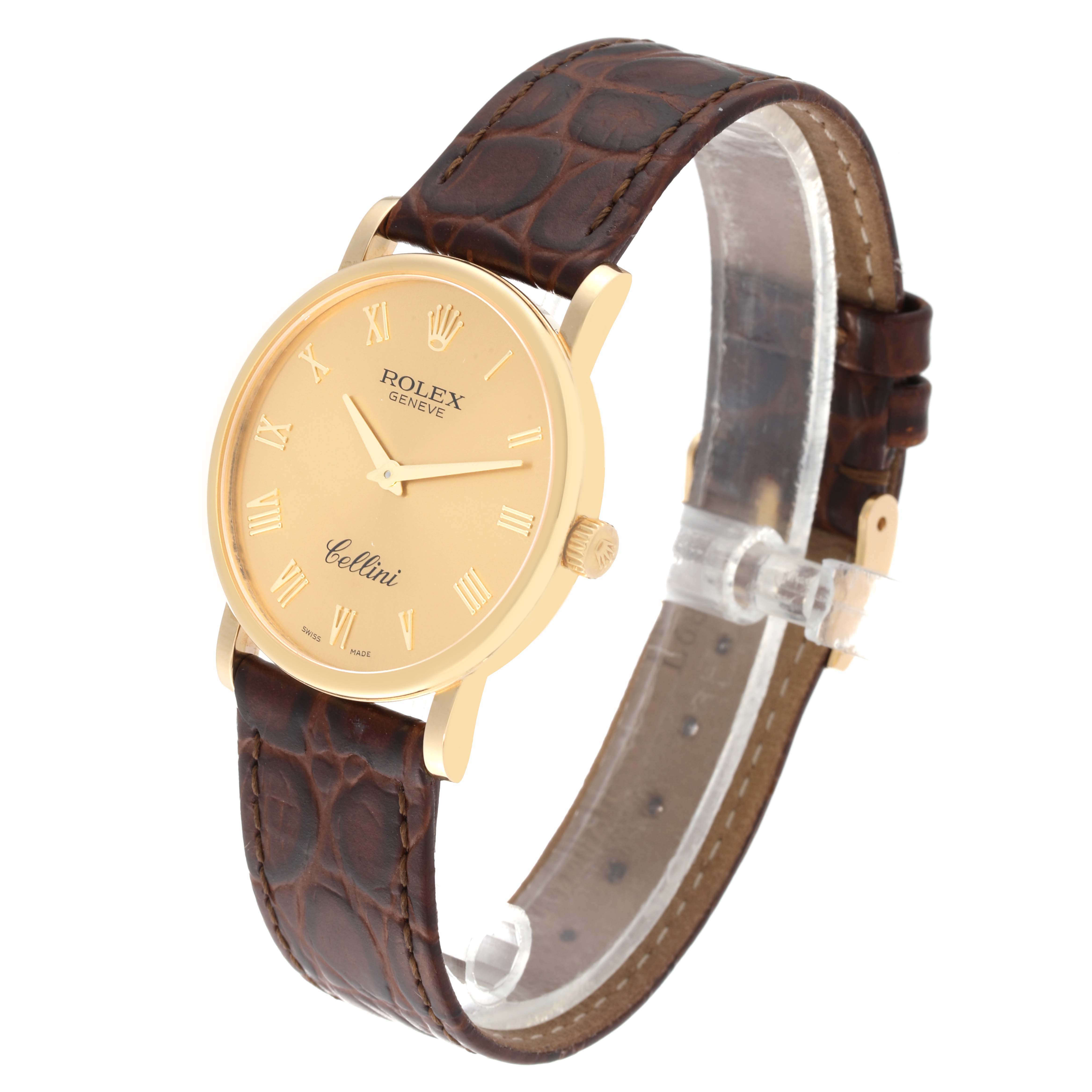 The Rolex Cellini 5115/8 Men's Yellow Gold Champagne Dial 5115/8 Men's Yellow Gold Champagne Dial watch is shown at a three-quarter angle, highlighting its gold case, Roman numeral dial, and brown leather strap.