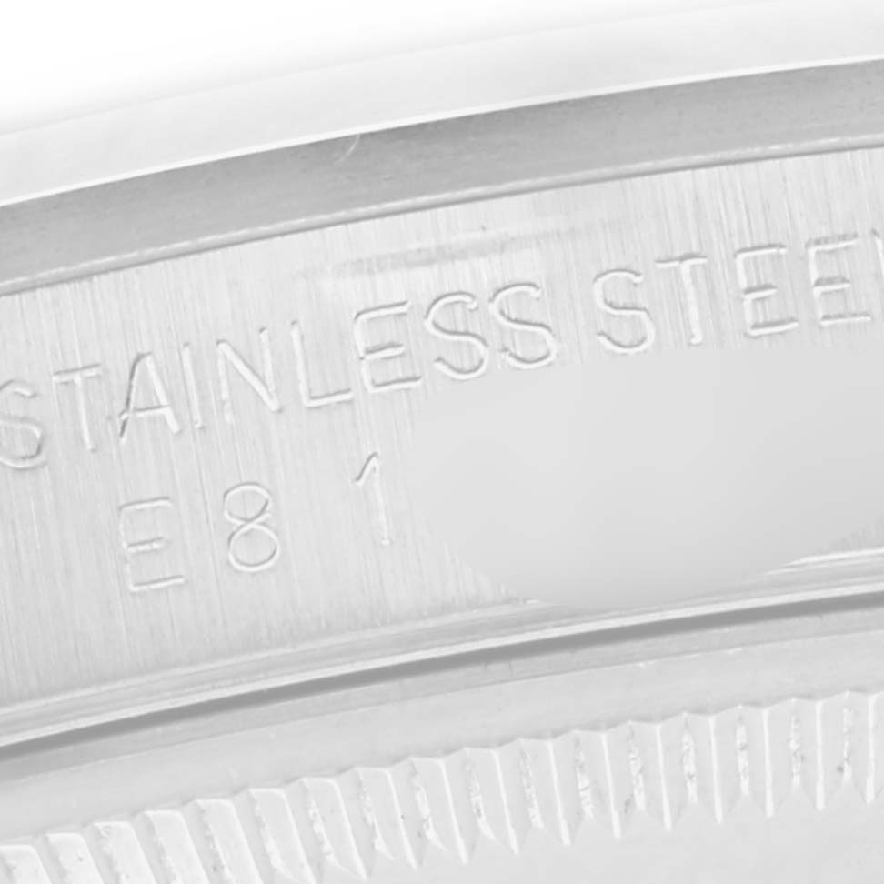 The image shows a close-up of the Rolex Date 15200 Men
s Stainless Steel White Dial 15200 Men
s Stainless Steel White Dial model
s stainless steel bezel with engraved text.