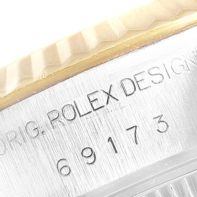 The image shows a close-up of the case side of a Rolex Datejust 69173 Women
s Steel and Gold (two tone) Champagne Dial 69173 Women
s Steel and Gold (two tone) Champagne Dial, highlighting the model number engraving and part of the bezel.