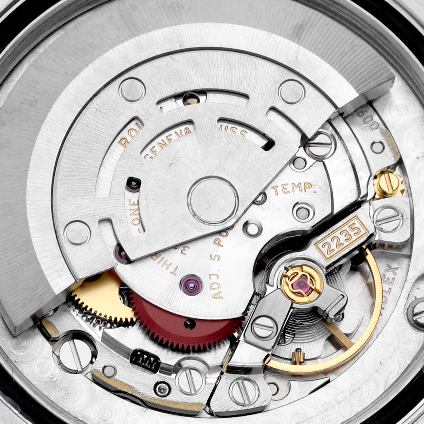 The image shows a close-up of the movement mechanism inside a Mid-Size Rolex watch.