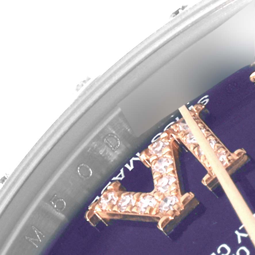 This close-up image of the Rolex Mid-Size 178341 Women's Steel and Gold (two tone) Purple Dial 178341 Women's Steel and Gold (two tone) Purple Dial model shows part of the watch face, a bejeweled hour marker, and the edge of the bezel.