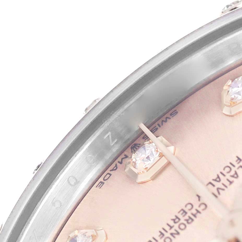 The image shows a close-up of the dial and bezel with diamond hour markers on a Mid-Size Rolex watch.